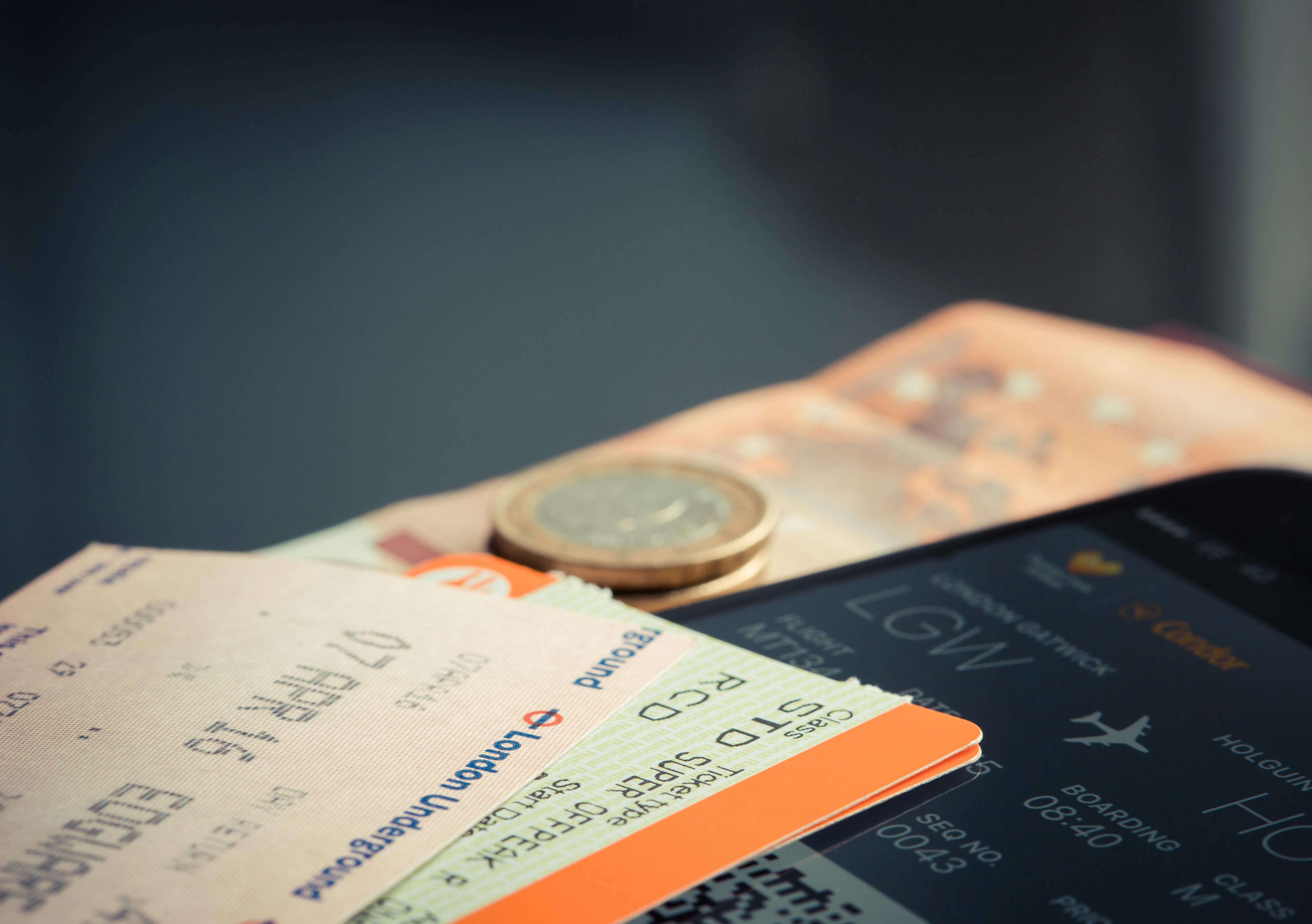 Airline tickets on a table with money | Source: Pexels