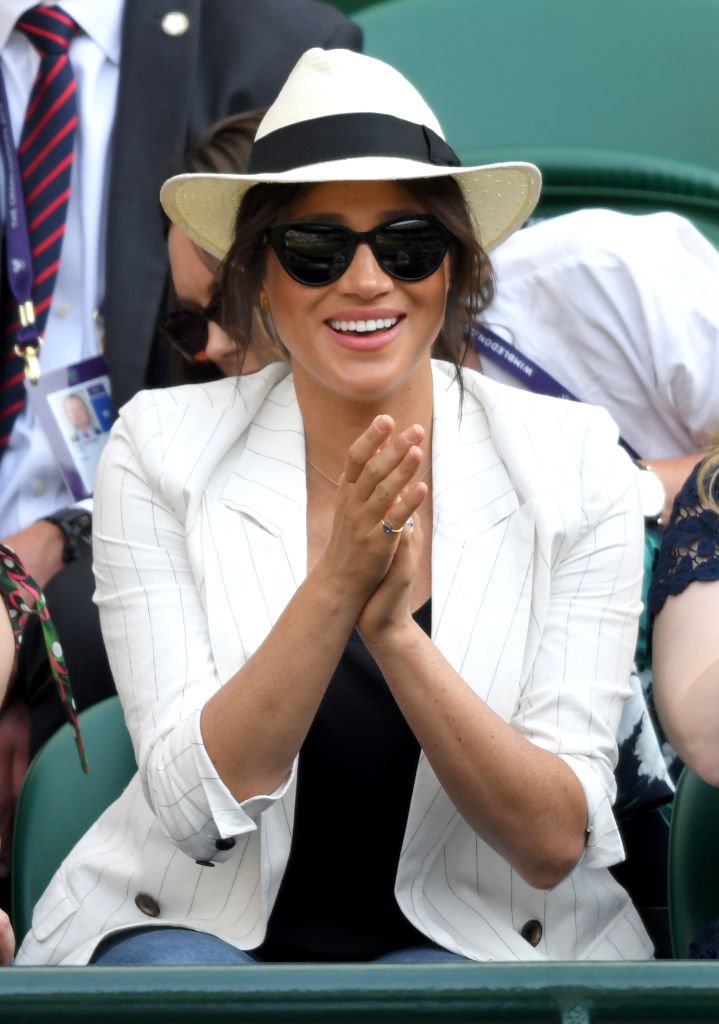 Meghan, Duchess of Sussex smiles as she attends day 4 of the Wimbledon Tennis Championships at the All England Lawn Tennis and Croquet Club | Photo: Getty Images