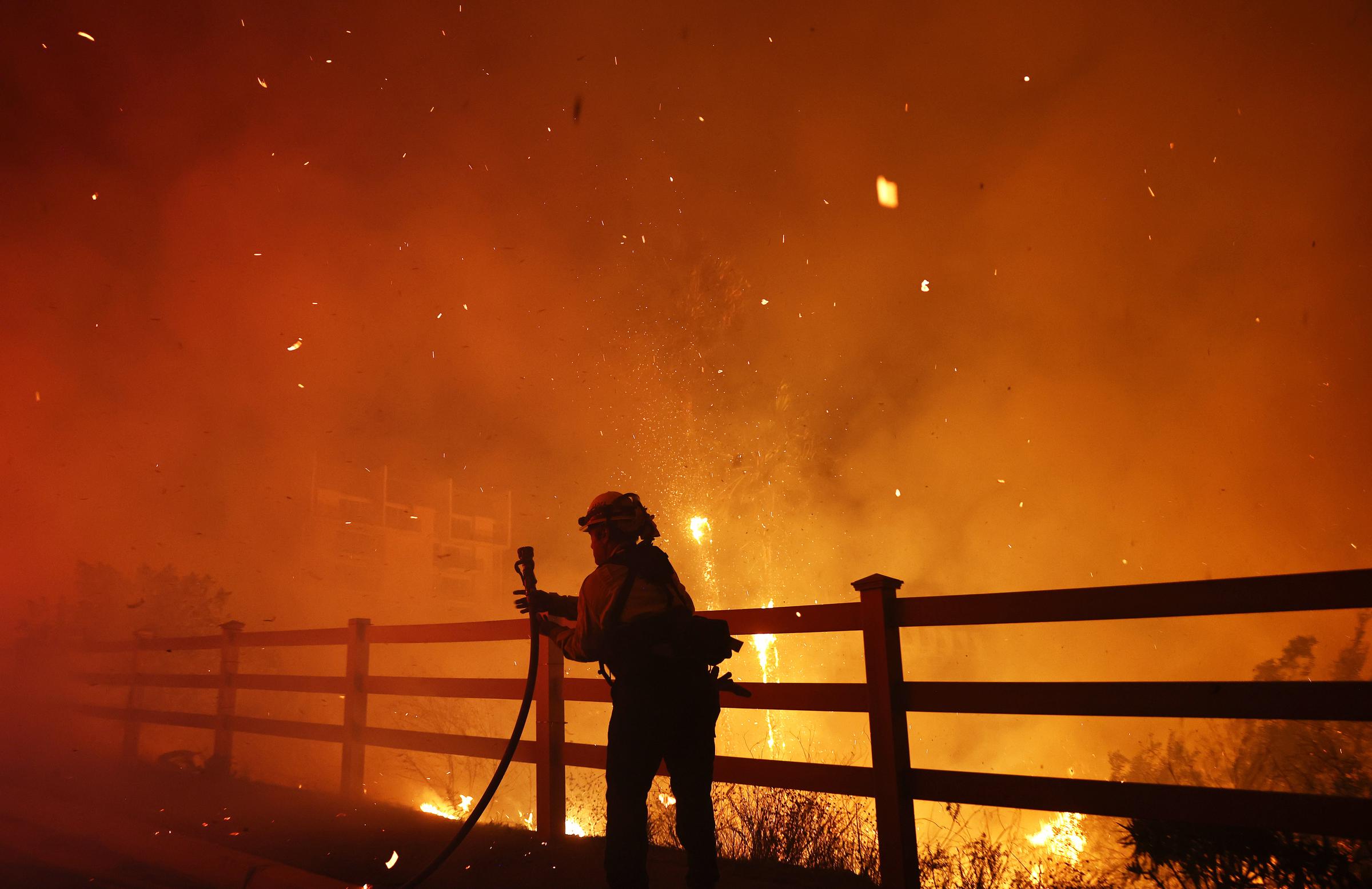 Firefighters battle a fire near Malibu, California, on December 10, 2024 | Source: Getty Images