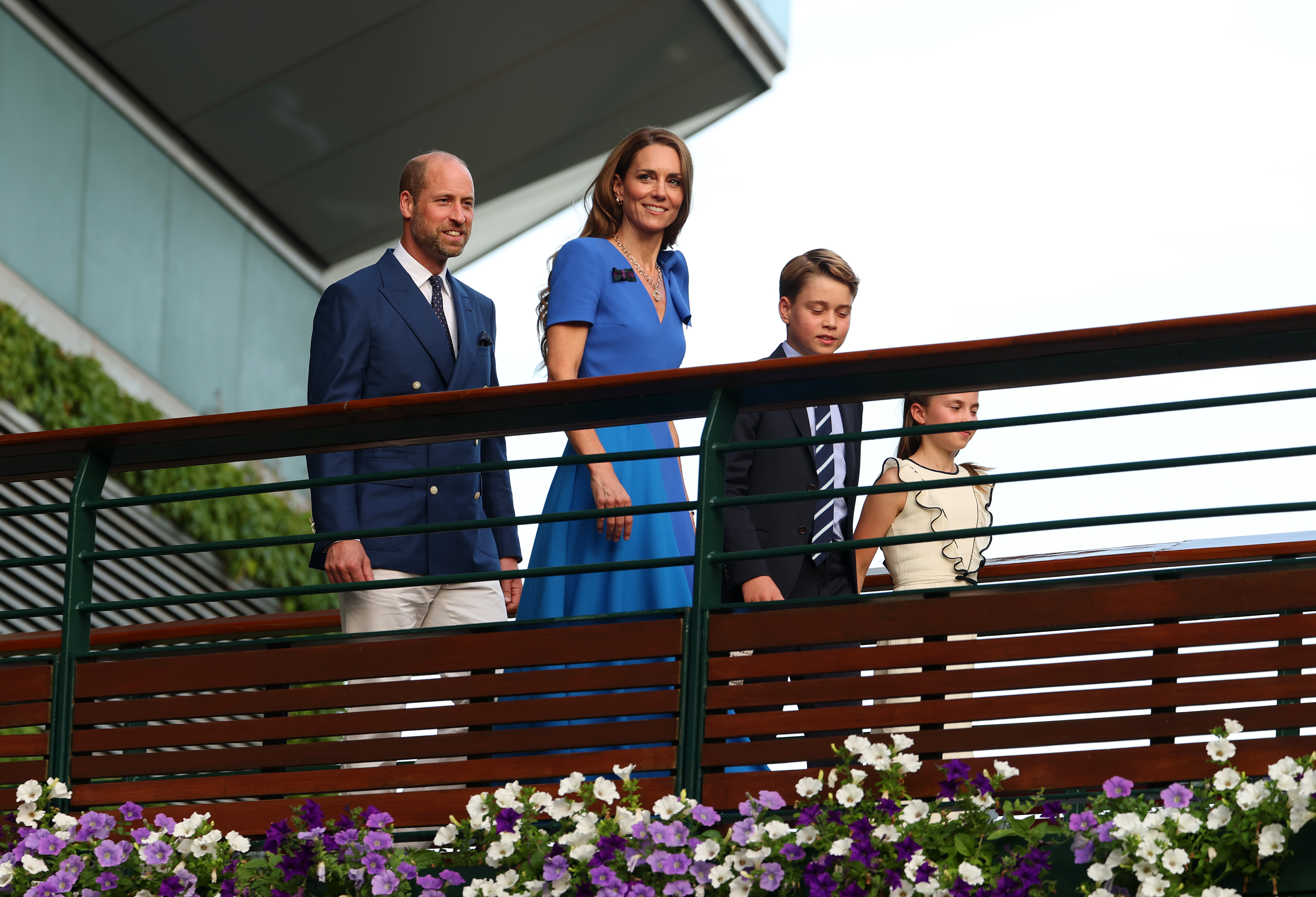 Prince William, Princess Catherine, Prince George, and Princess Charlotte cross the player's walkway bridge at The Championships Wimbledon held at the All England Lawn Tennis and Croquet Club in London, on July 13, 2025 | Source: Getty Images