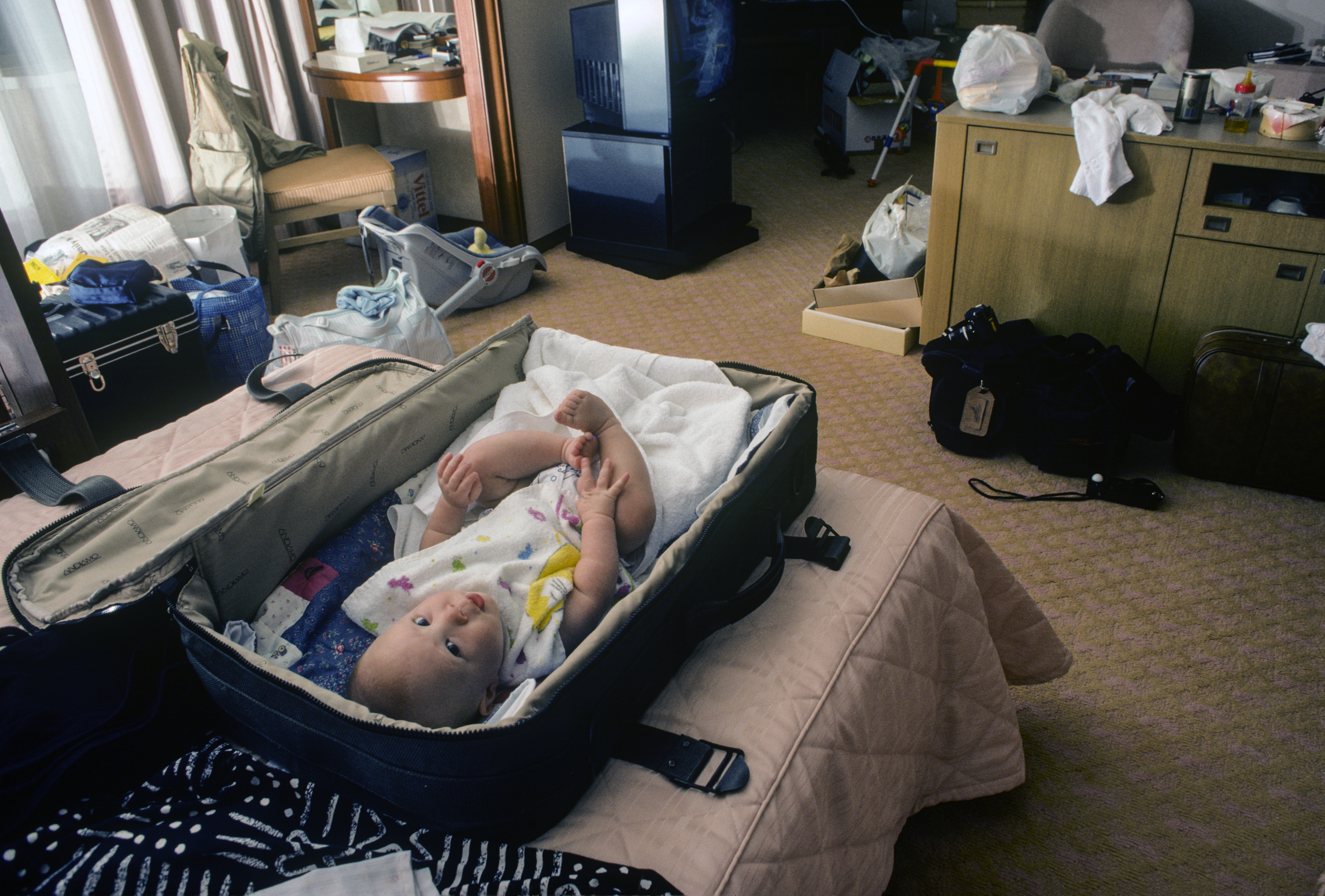 Baby lying in a suitcase | Source: Getty Images
