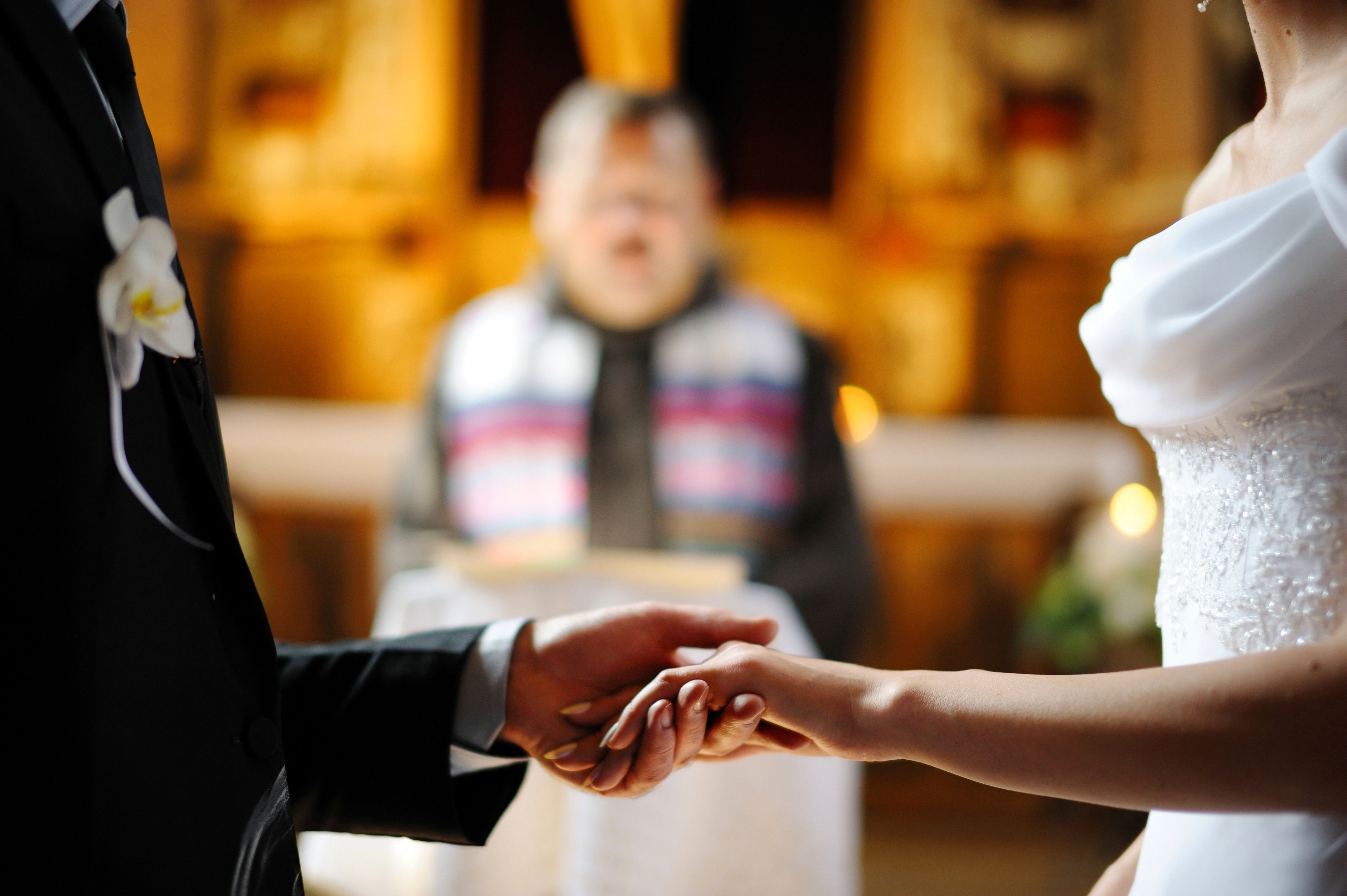 A bride and groom holding hands during wedding ceremony | Source: Shutterstock