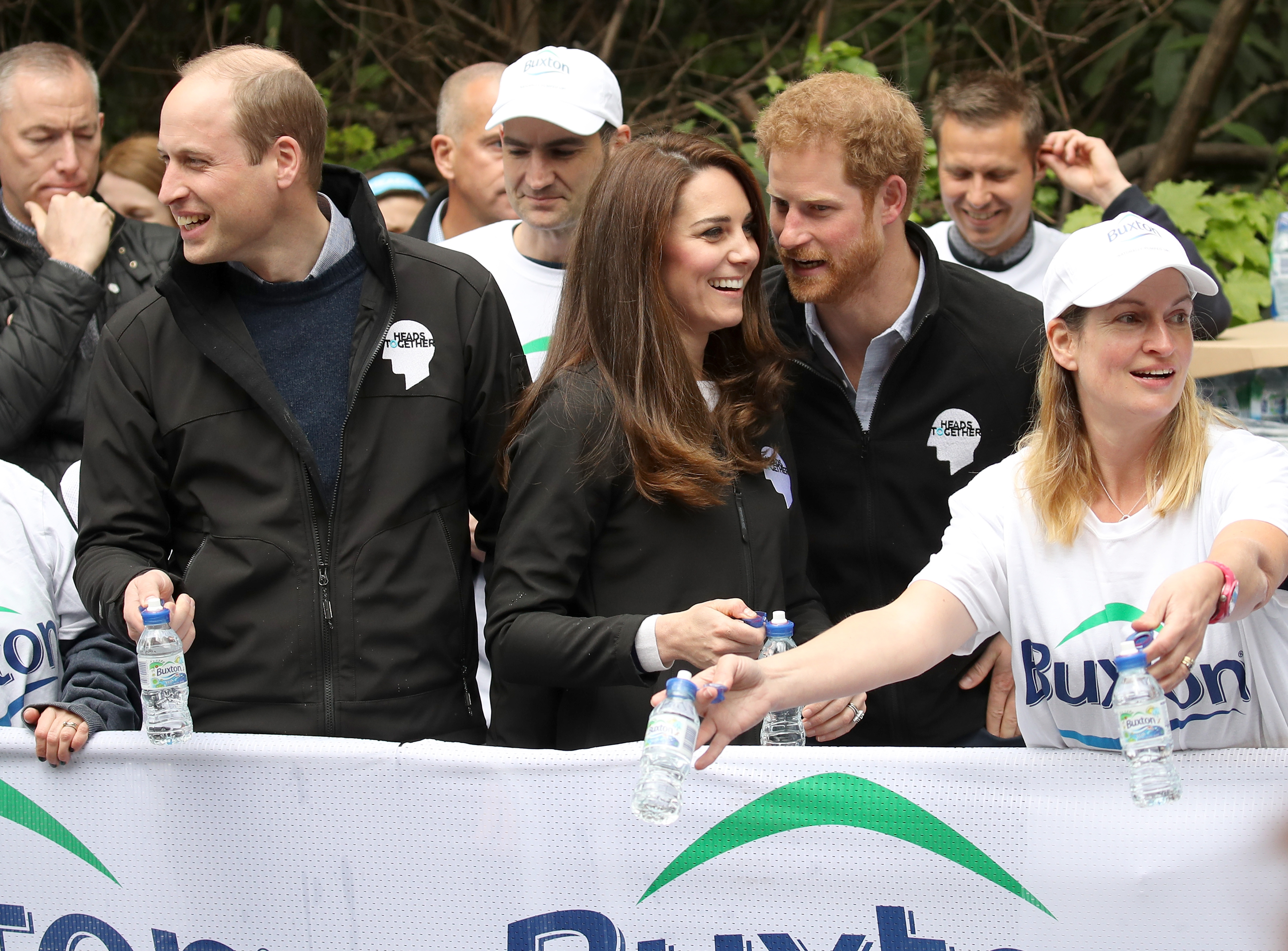 Prince William, Princess Catherine, and Prince Harry cheering on and handing out water to runners during the 2017 Virgin Money London Marathon on April 23, 2017, in London, England. | Source: Getty Images