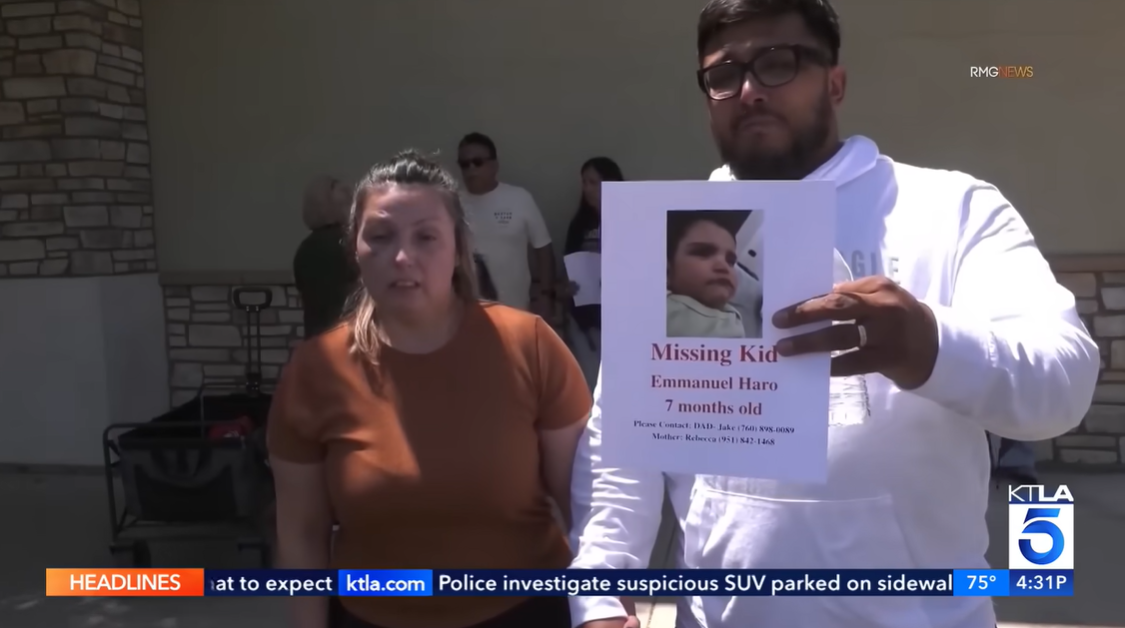 Rebecca and Jake Haro appear at a public gathering holding a missing persons flyer for their son, Emmanuel Haro, in a video posted on August 20, 2025 | Source: YouTube/5live