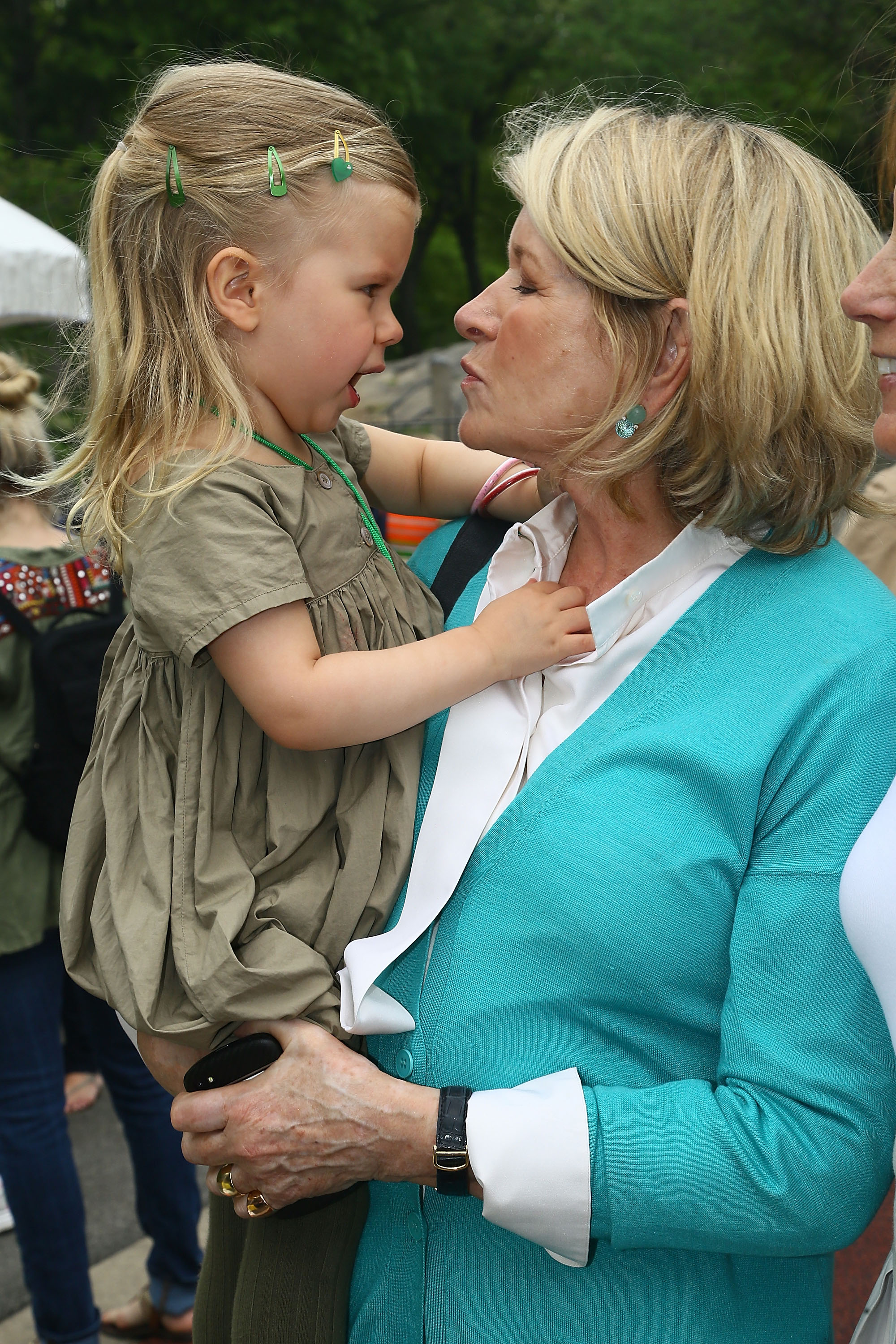 Martha Stewart pictured holding her granddaughter Jude Stewart as they glare into each other's eyes. | Source: Getty Images