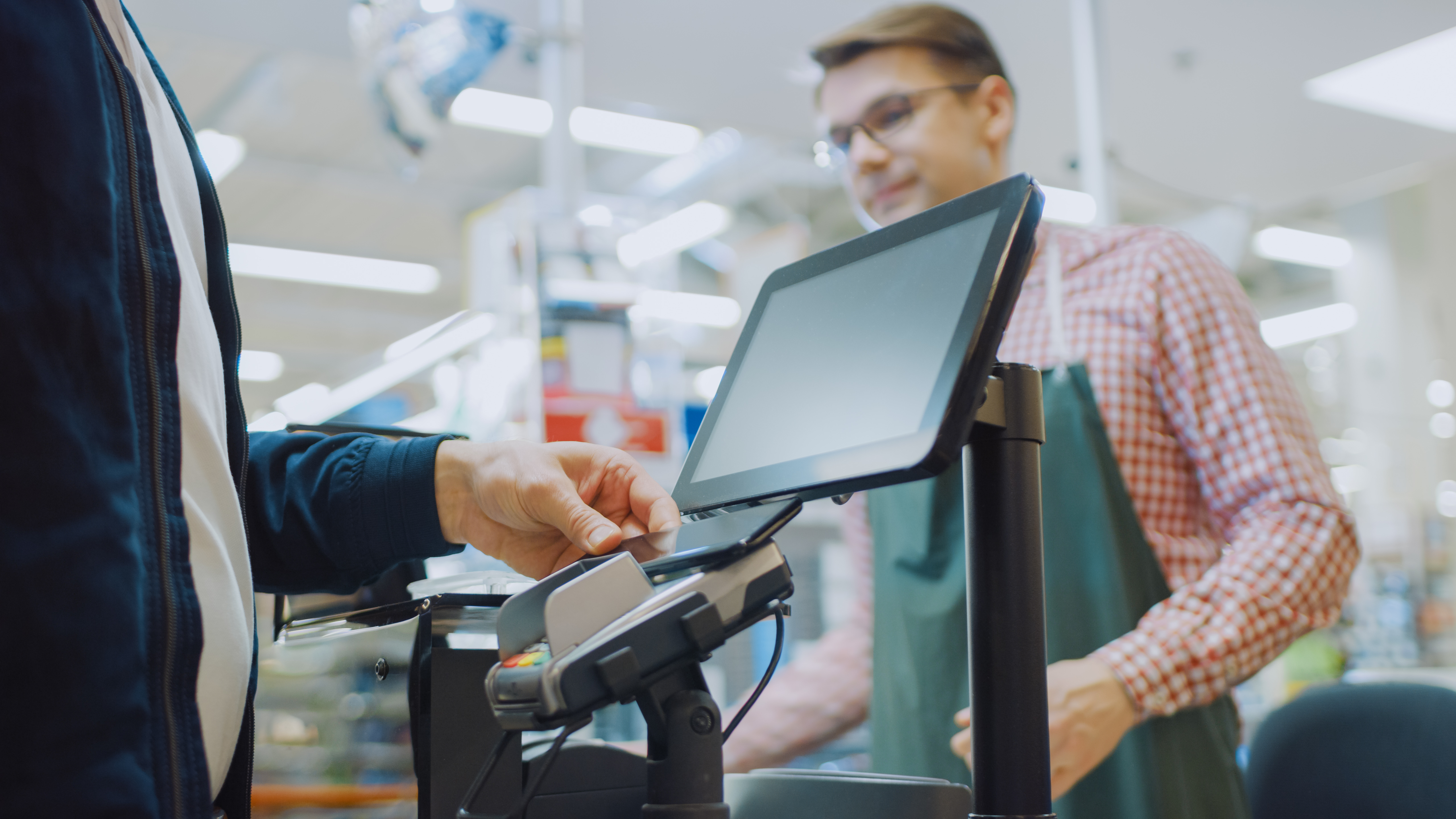 A person working at a checkout counter | Source: Shutterstock