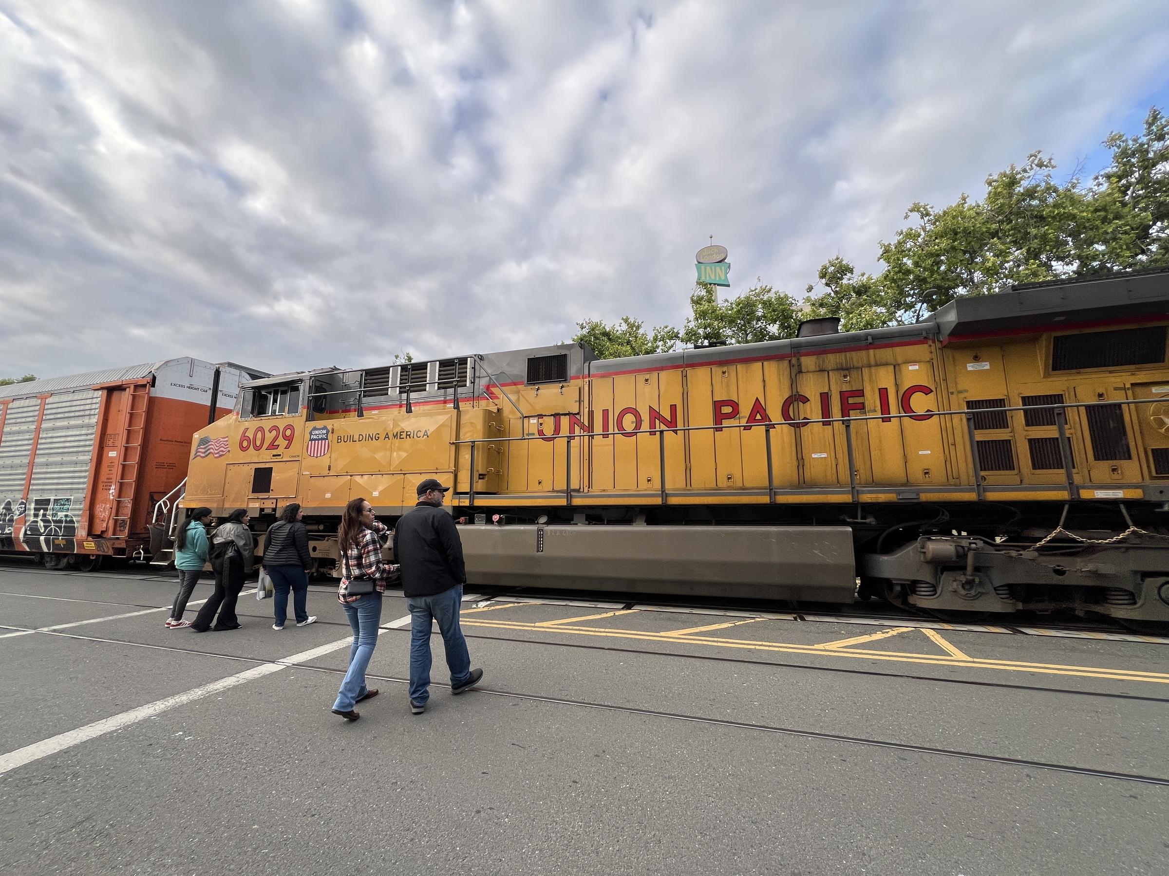 Pedestrians approach a Union Pacific freight train. | Source: Getty Images