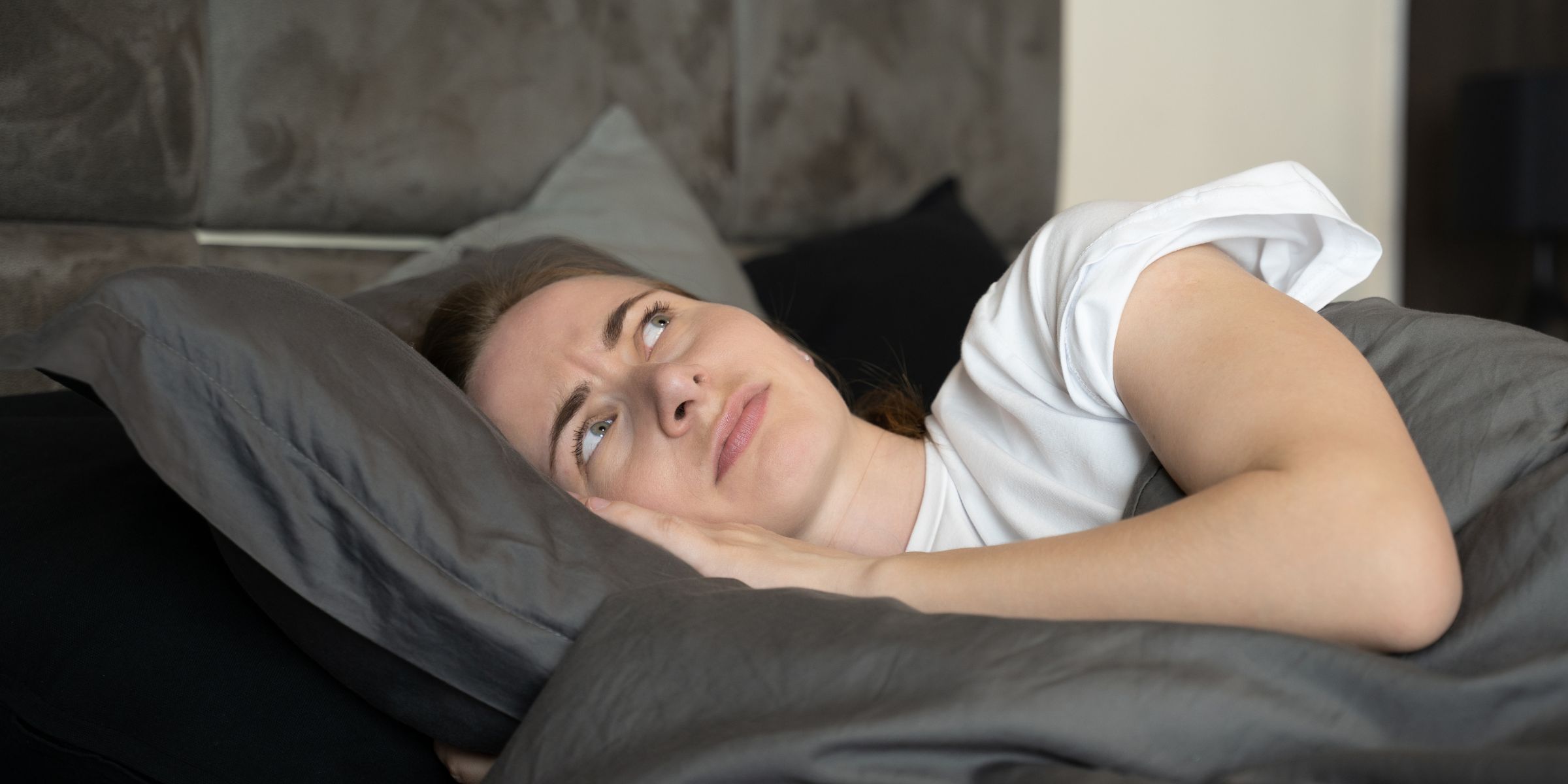 Woman lying awake in bed | Source: Shutterstock
