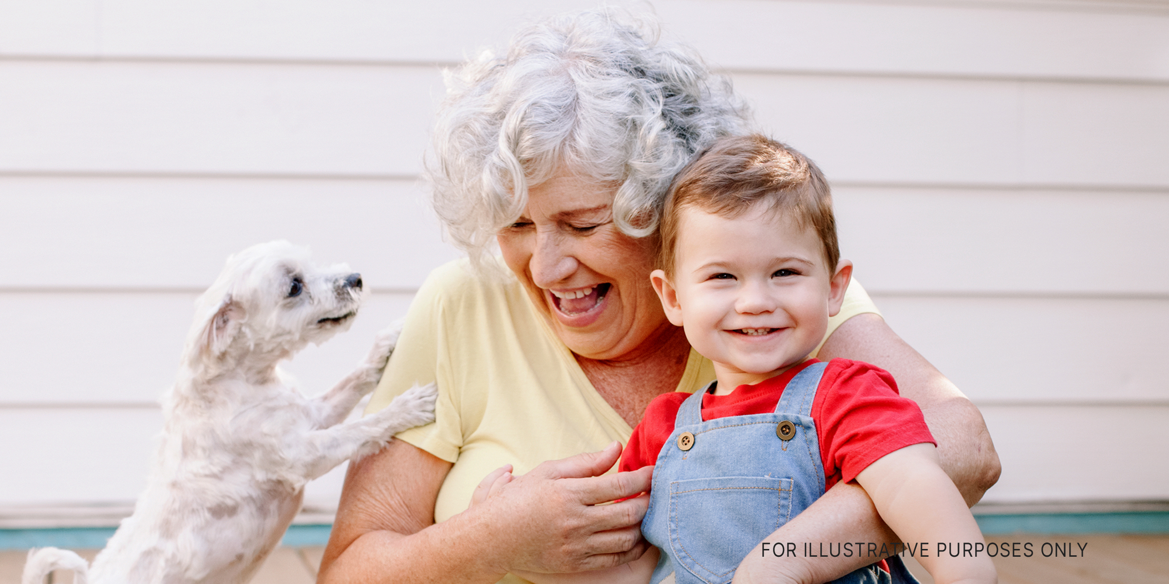 A grandmother and her grandchild with a puppy | Source: Shutterstock