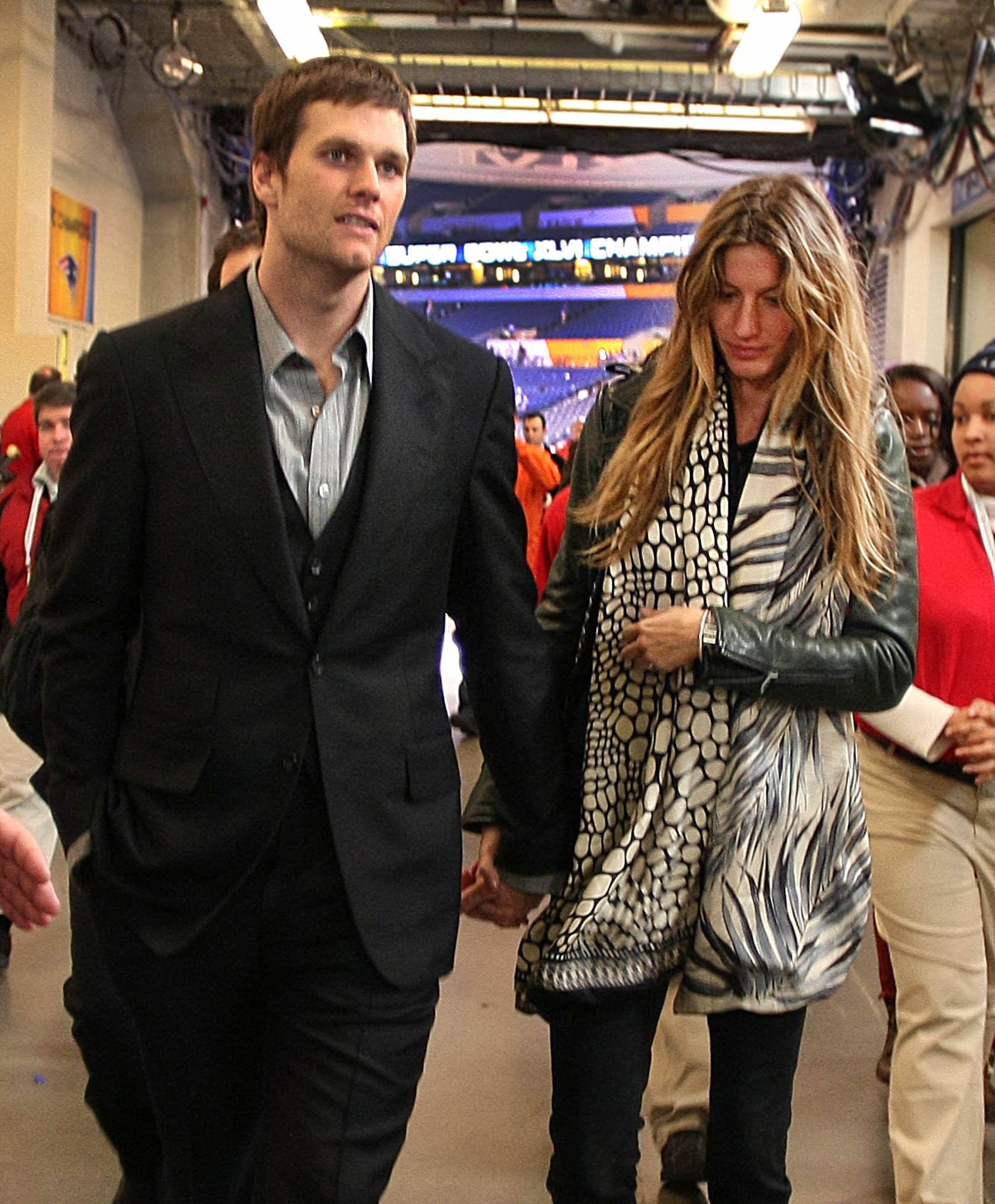 Tom Brady walks from a press conference at the end of the Super Bowl with wife, Giselle. | Source: Getty Images