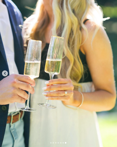 A close-up of David Andersen and Paige Drummond's champagne flutes on their engagement day, posted on August 5, 2024 | Source: Instagram/a_paige_in_my_book