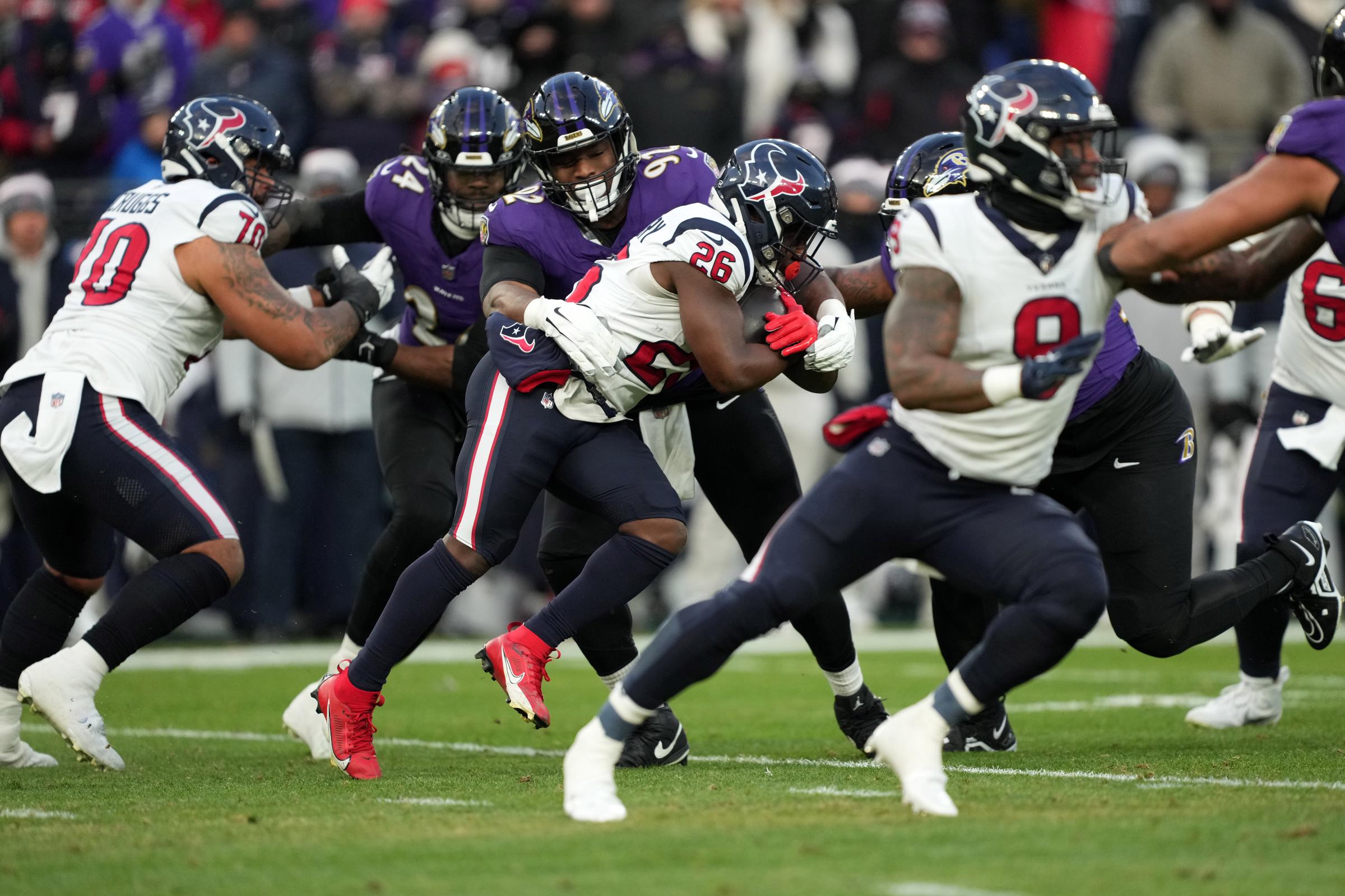 Baltimore Ravens defensive tackle Justin Madubuike tackles Houston Texans running back Devin Singletary in the first half in the AFC Divisional Playoff game at M&T Bank Stadium in Baltimore, Maryland, on January 20, 2024 | Source: Getty Images