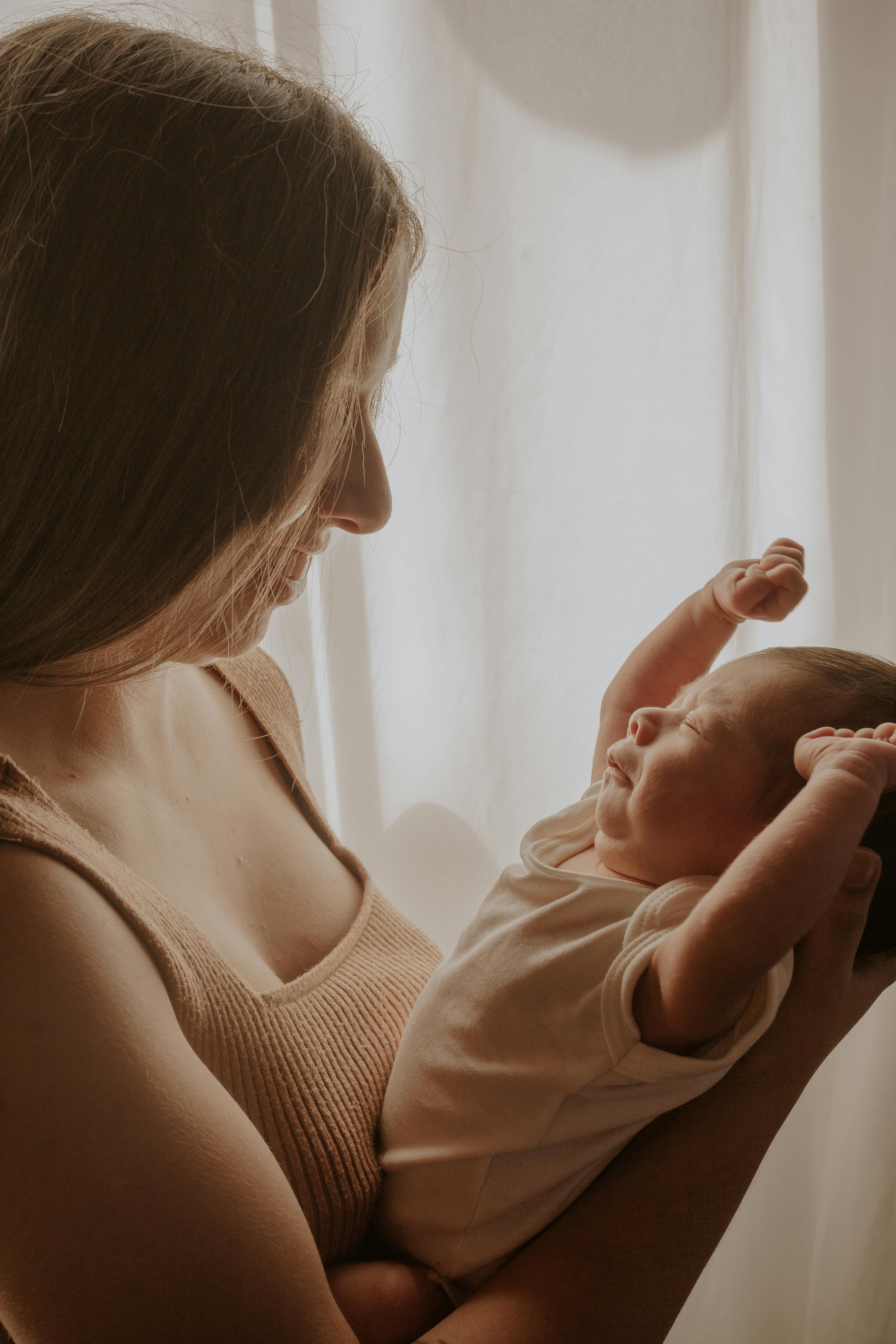 A woman holding her baby | Source: Pexels
