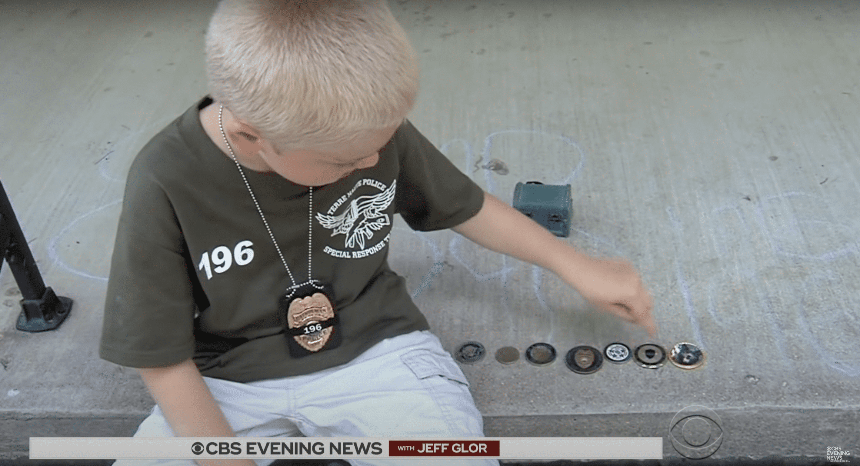 Dakota Pitts shows his challenge coins collection | Source: YouTube.com/CBS Evening News