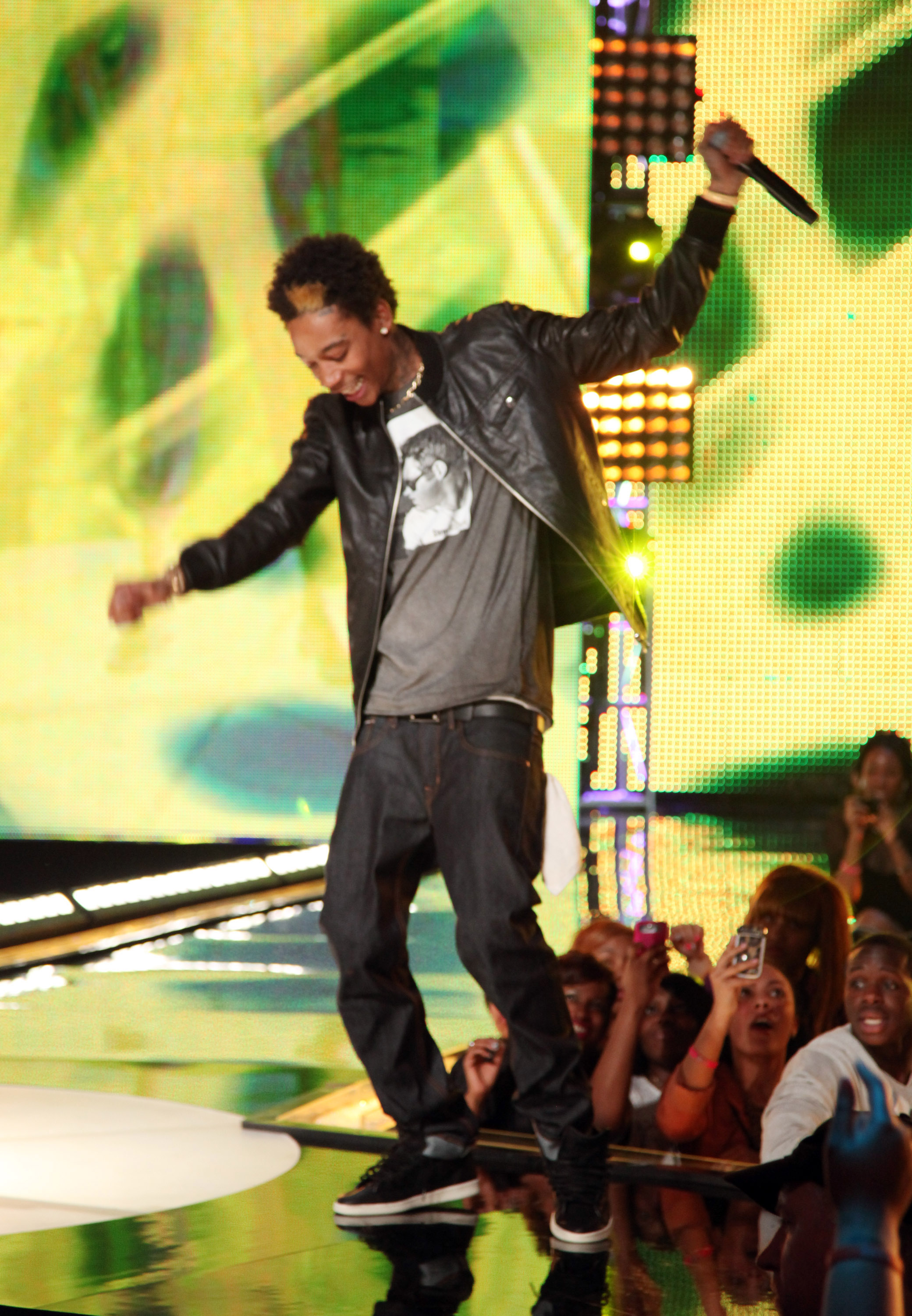 At just 23 years old, Wiz Khalifa took the stage at BET's Rip the Runway 2011 at The Manhattan Center in New York City on February 26, 2011. Dressed in a leather jacket and jeans, the rapper's noticeably slender frame reflected the look fans had come to associate with him long before his later MMA-inspired physical transformation.