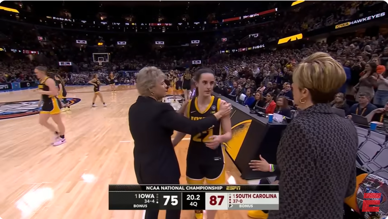 Caitlin Clark and her coaches during the Iowa Hawkeyes vs. South Carolina Gamecocks match in Cleveland, Ohio from a video dated April 8, 2024. | Source: Youtube/@espn