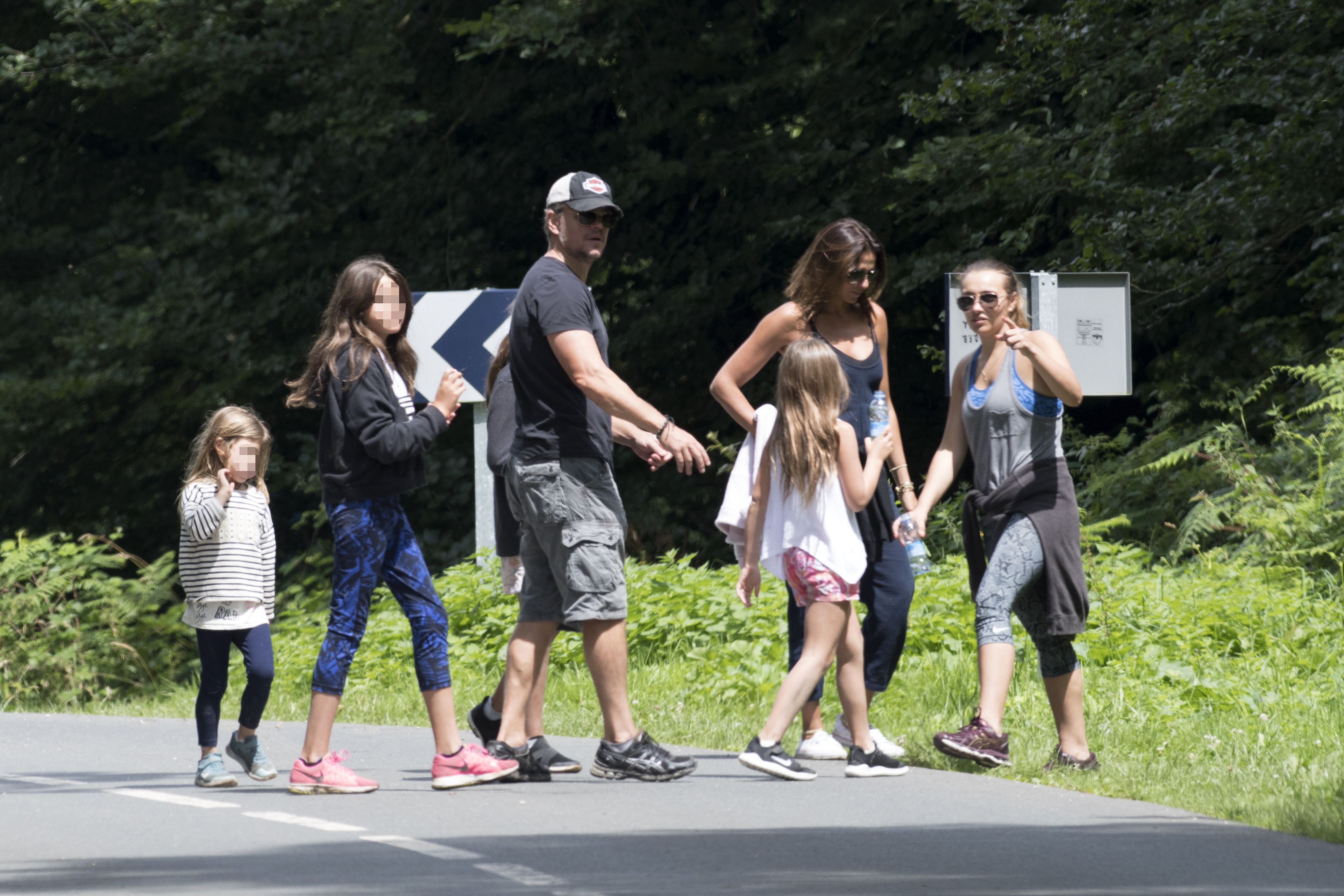 Matt Damon and Luciana Damon are joined by their daughters during a family walk, offering a rare glimpse into life away from Hollywood. | Source: Getty Images