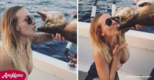 Woman films herself drinking beer from gutted fish's mouth