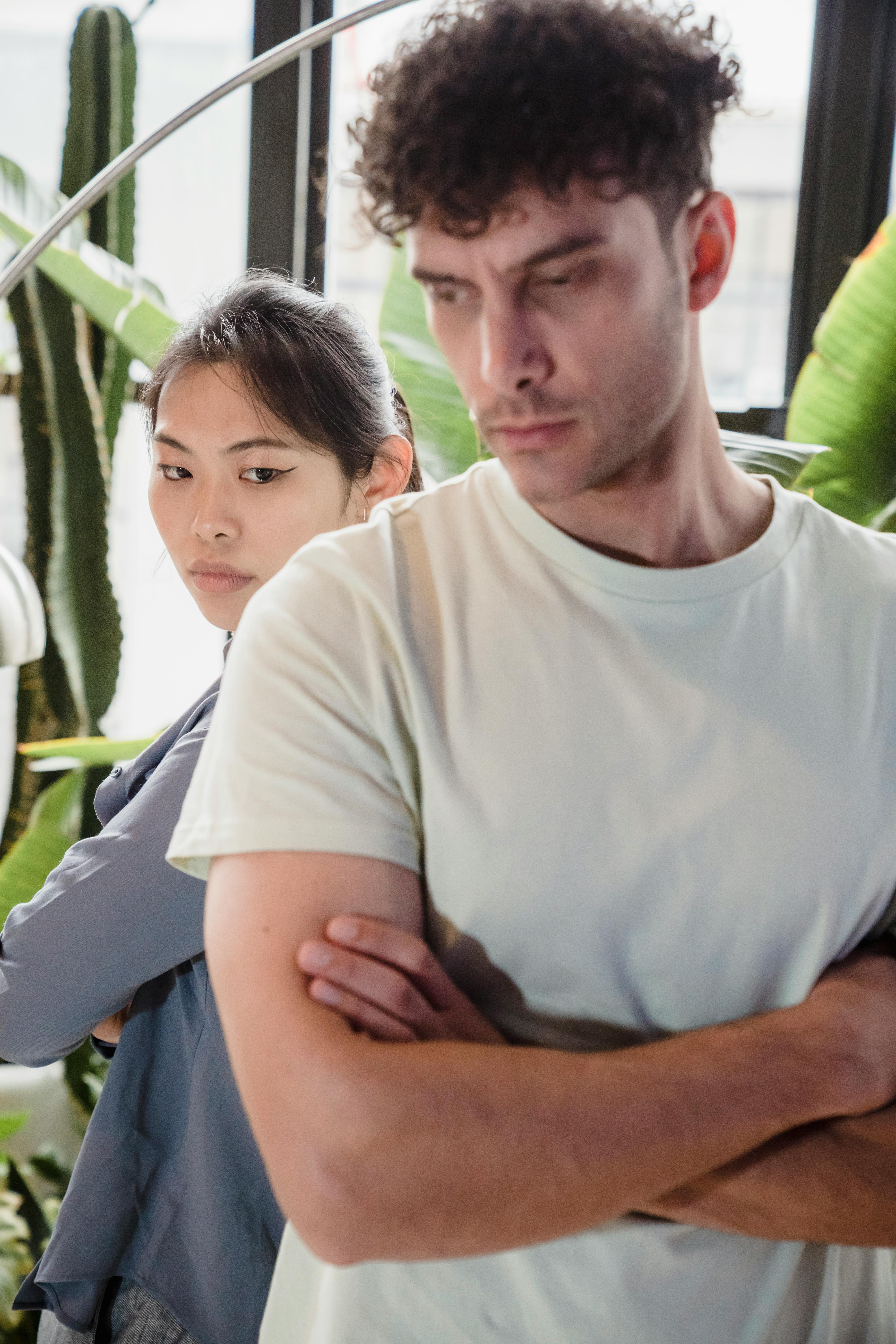 A woman looking over her shoulder as a man stands behind her | Source: Pexels