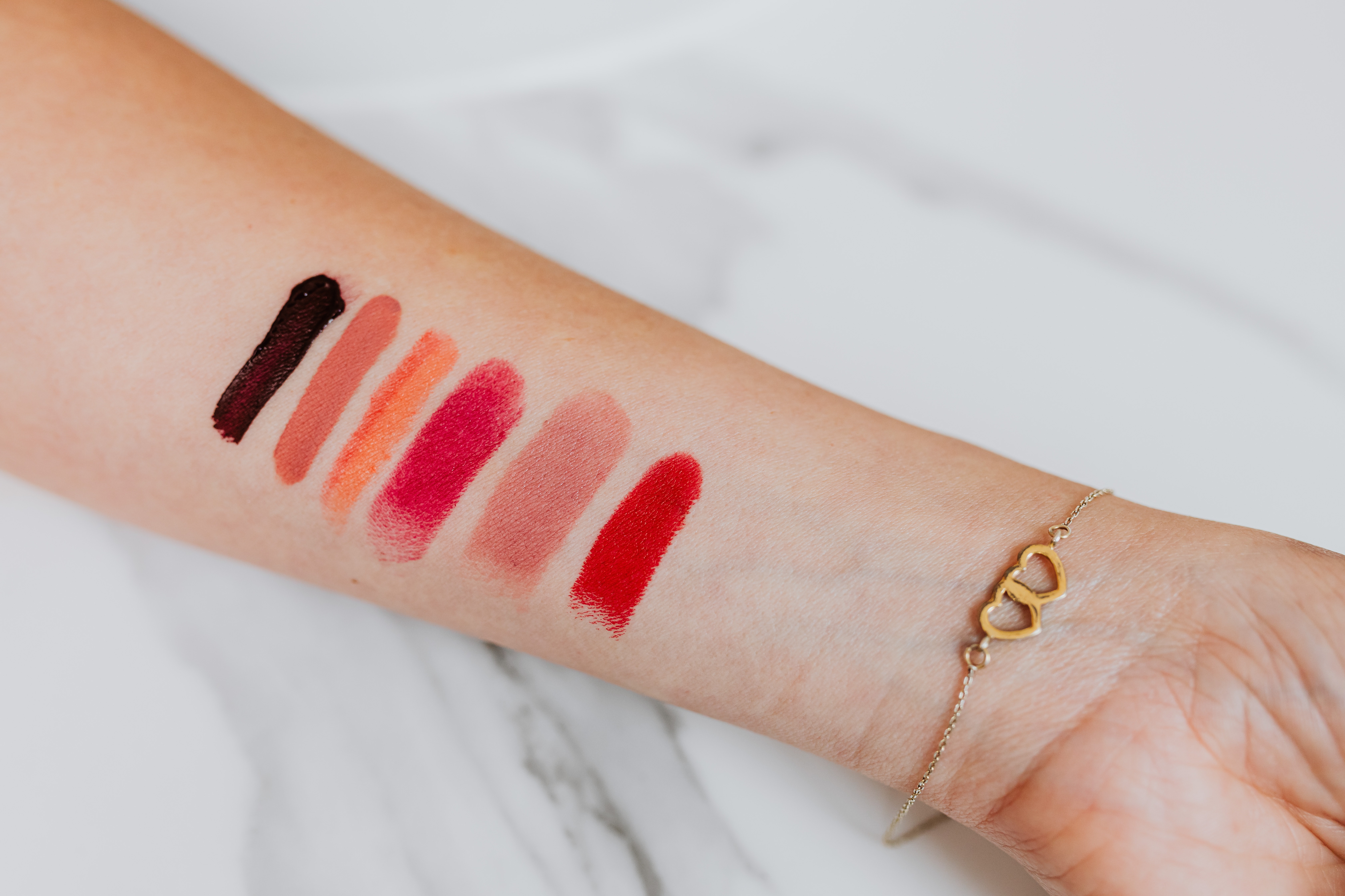 Different lipstick shades on a woman's arm. │Source: Pexels