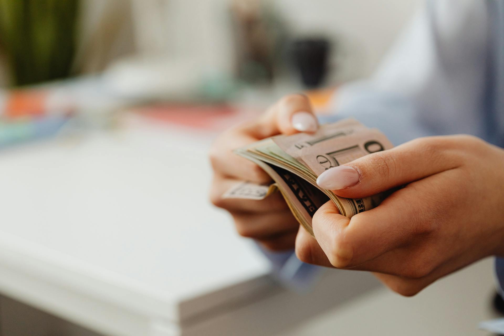 A woman holding money | Source: Pexels
