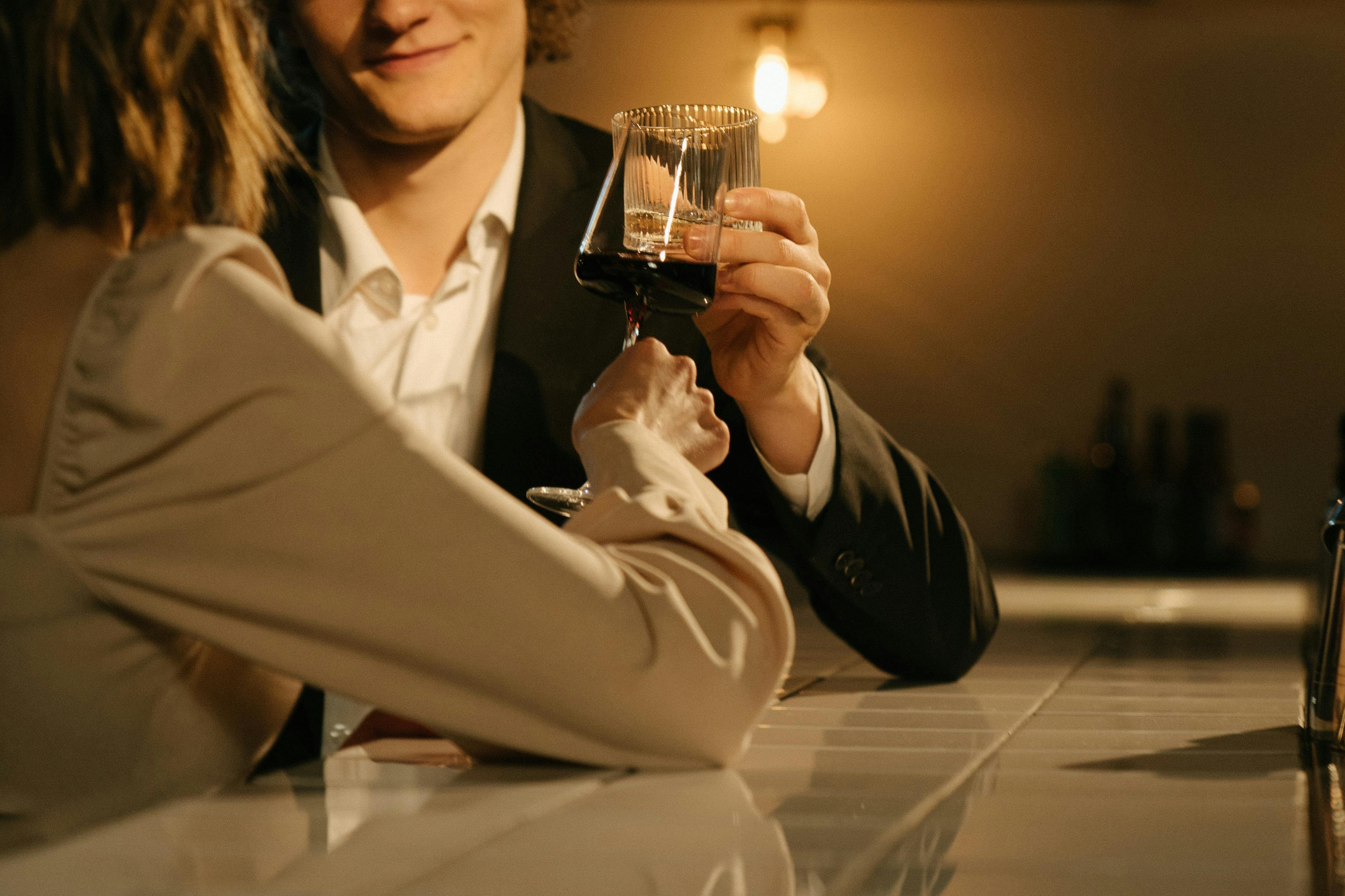 A happy couple toasting some good news at a restaurant | Source: Pexels