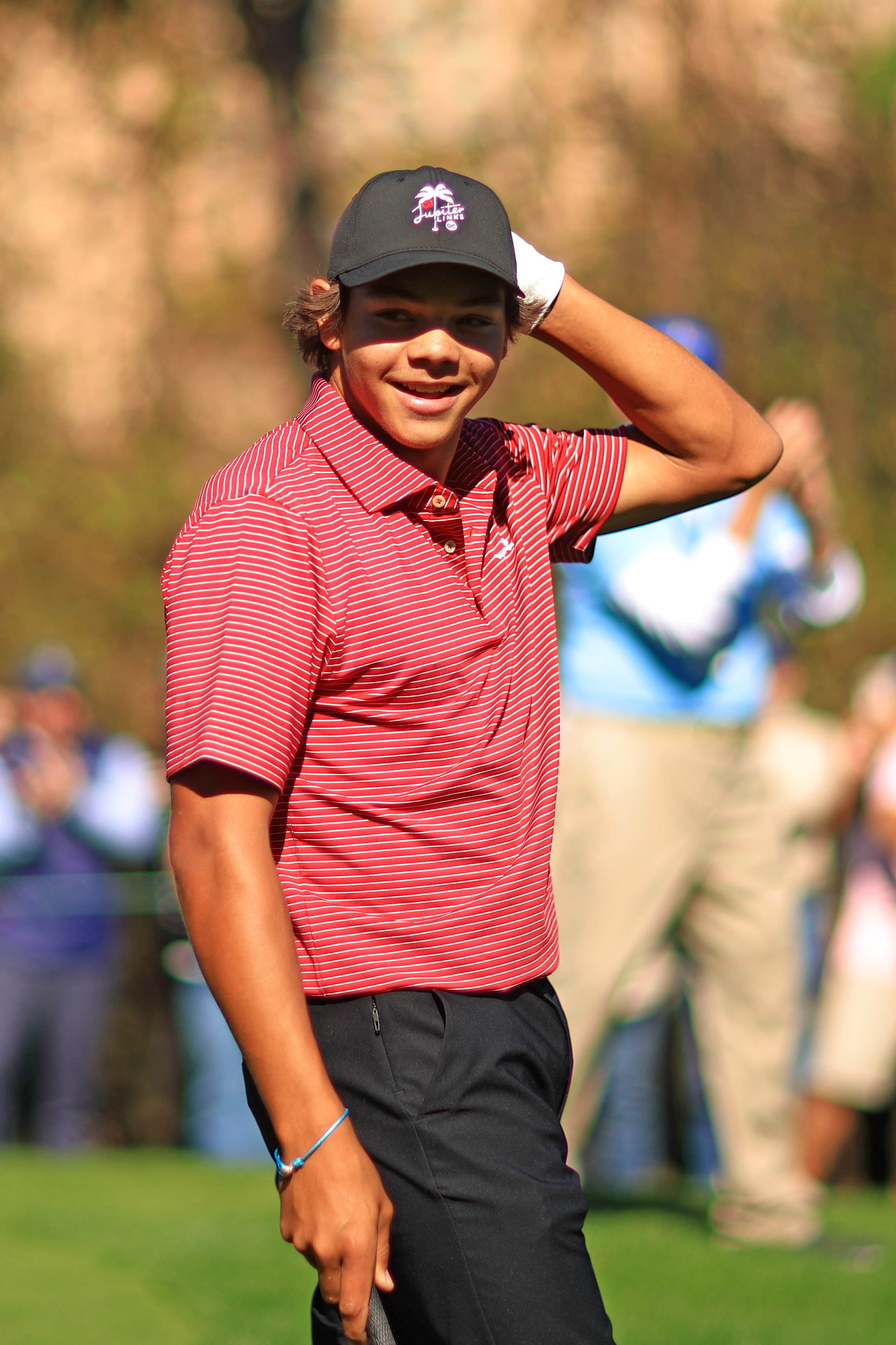 Charlie Woods reacts after holing out on the fourth hole at the 2024 PNC Championship on December 22, 2024 | Source: Getty Images