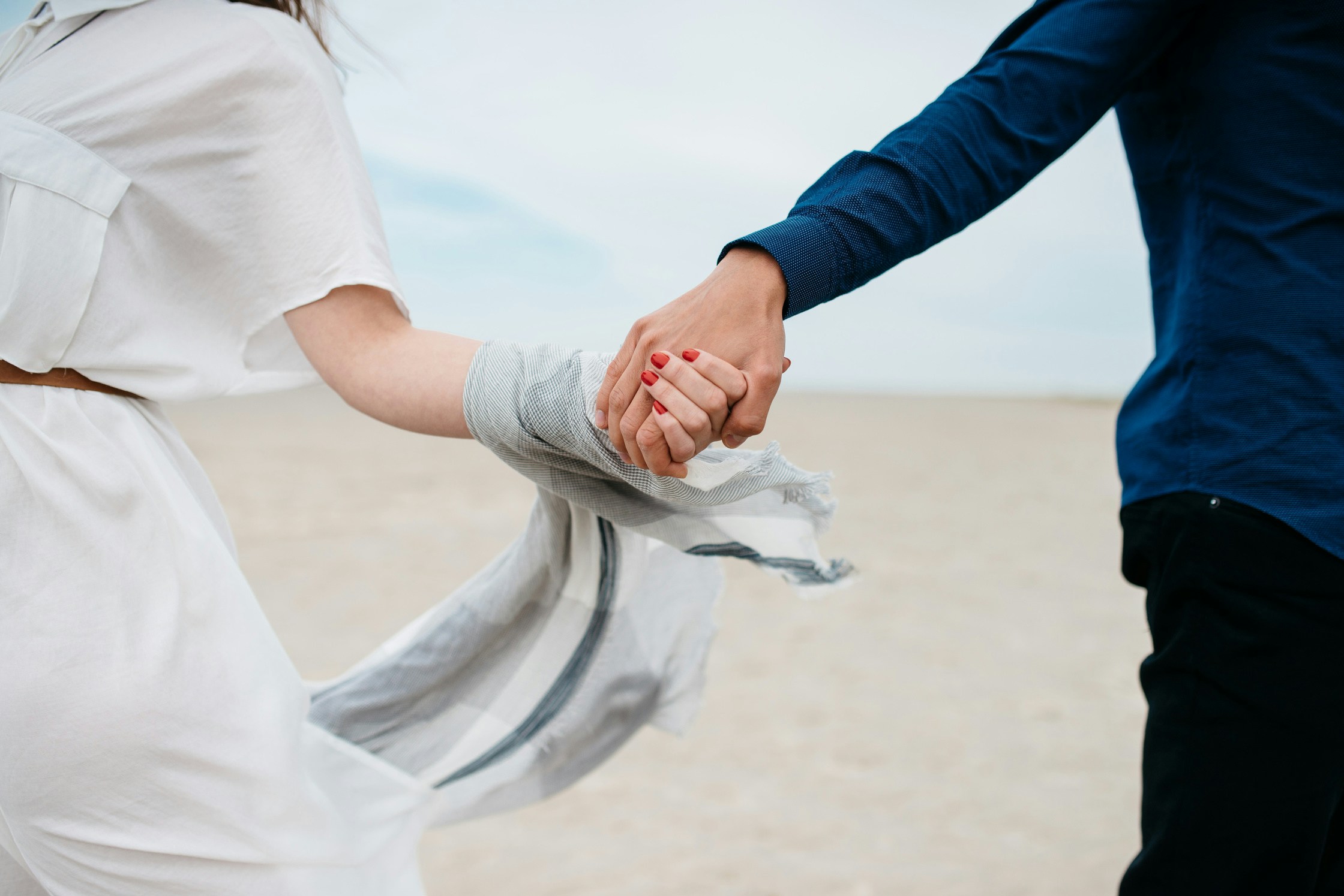 A romantic couple holding hands | Source: Unsplash