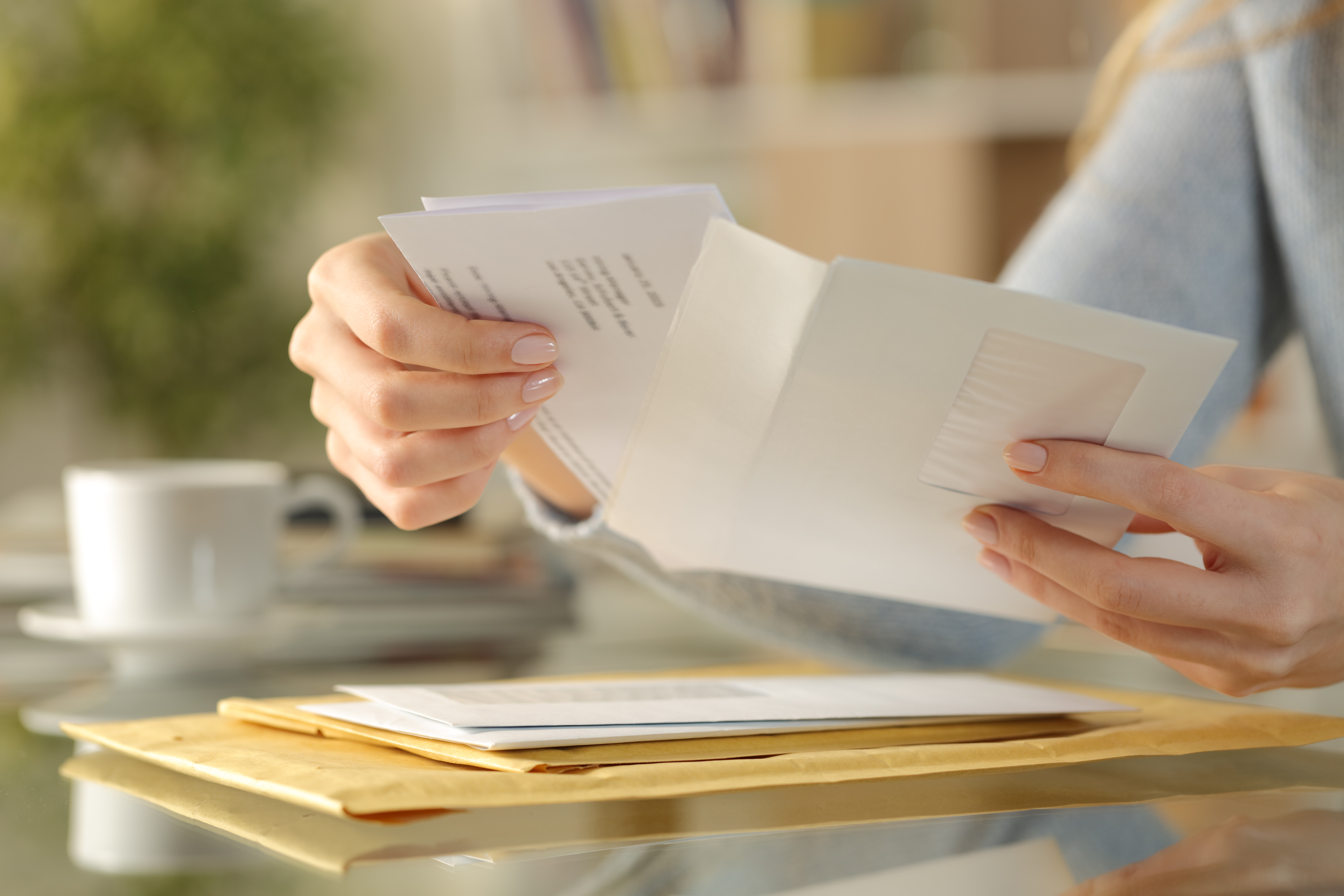A person opening an envelope | Source: Pexels