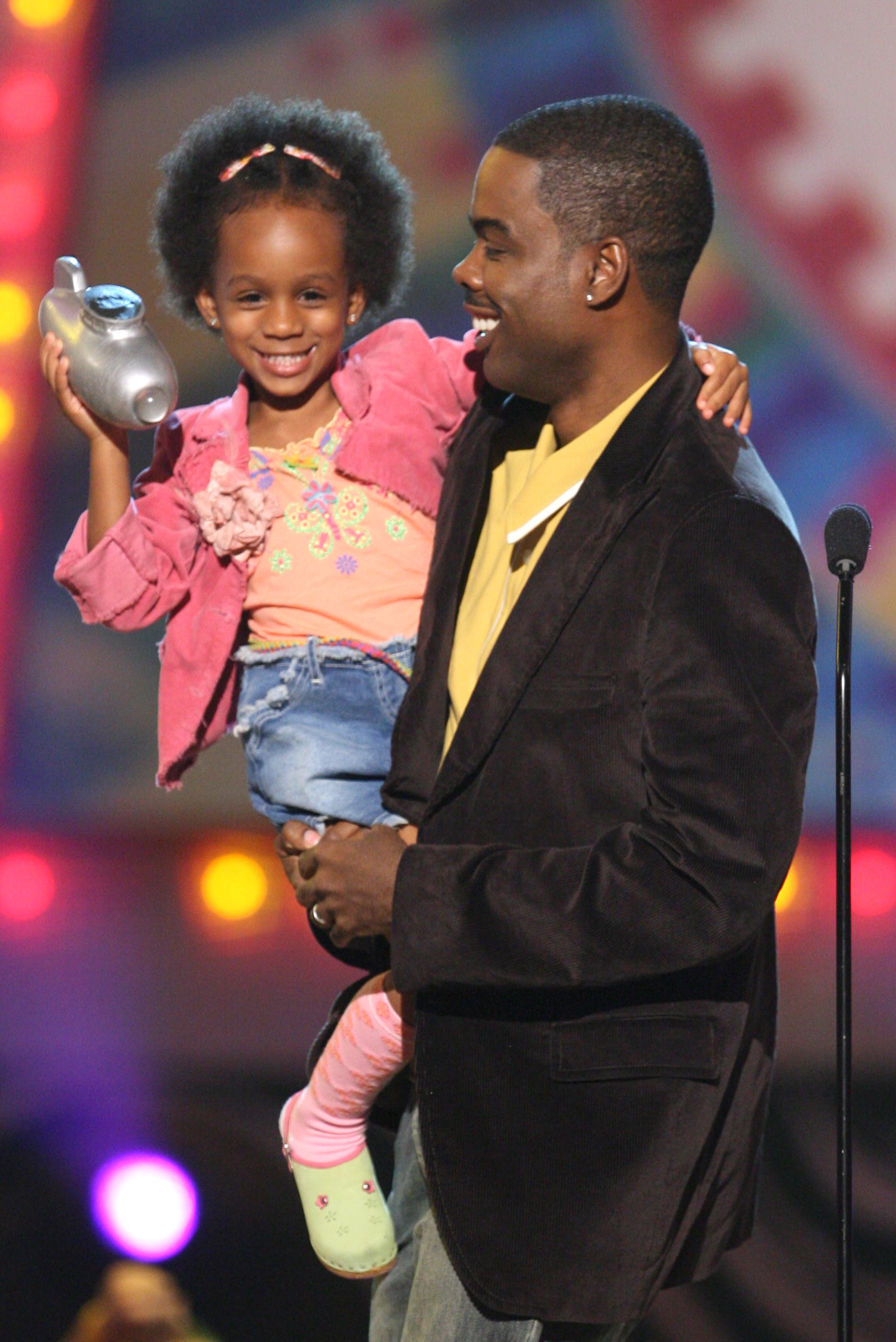 Lola Rock and her dad, Chris Rock, are pictured onstage during Nickelodeon's 19th Annual Kids' Choice Awards at the Pauley Pavilion on an unspecified date in Westwood, California | Source: Getty Images