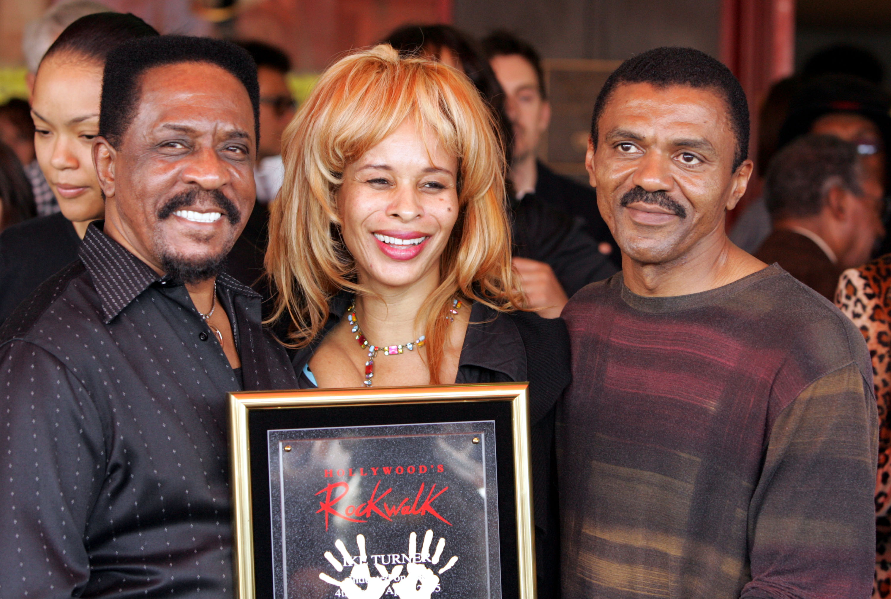 Ike Turner (L) stands with his son Ike Jr. and guest Audrey Madison are in Hollywood, California  on April 4, 2005 | Source: Getty Images