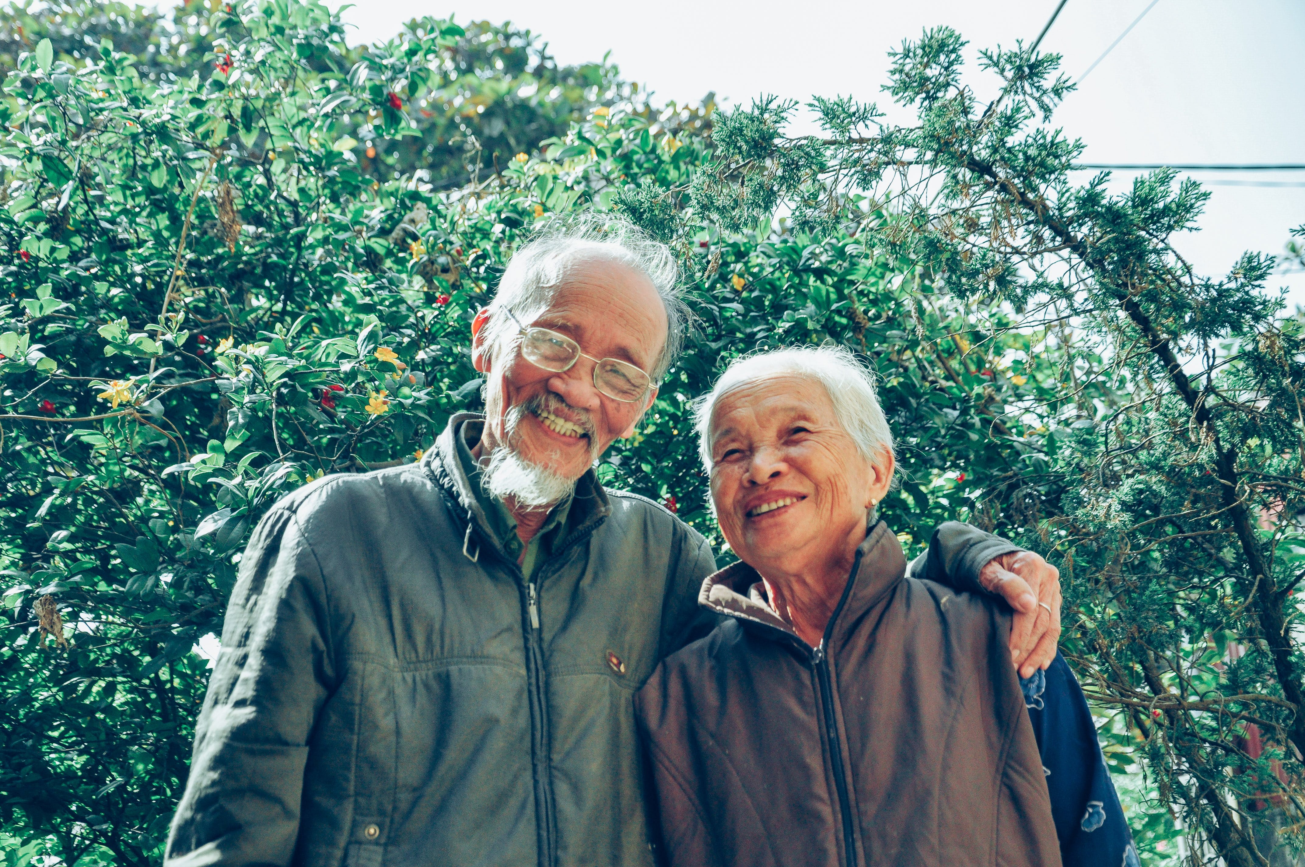 An older couple embracing and smiling while standing outside | Source: Pexels