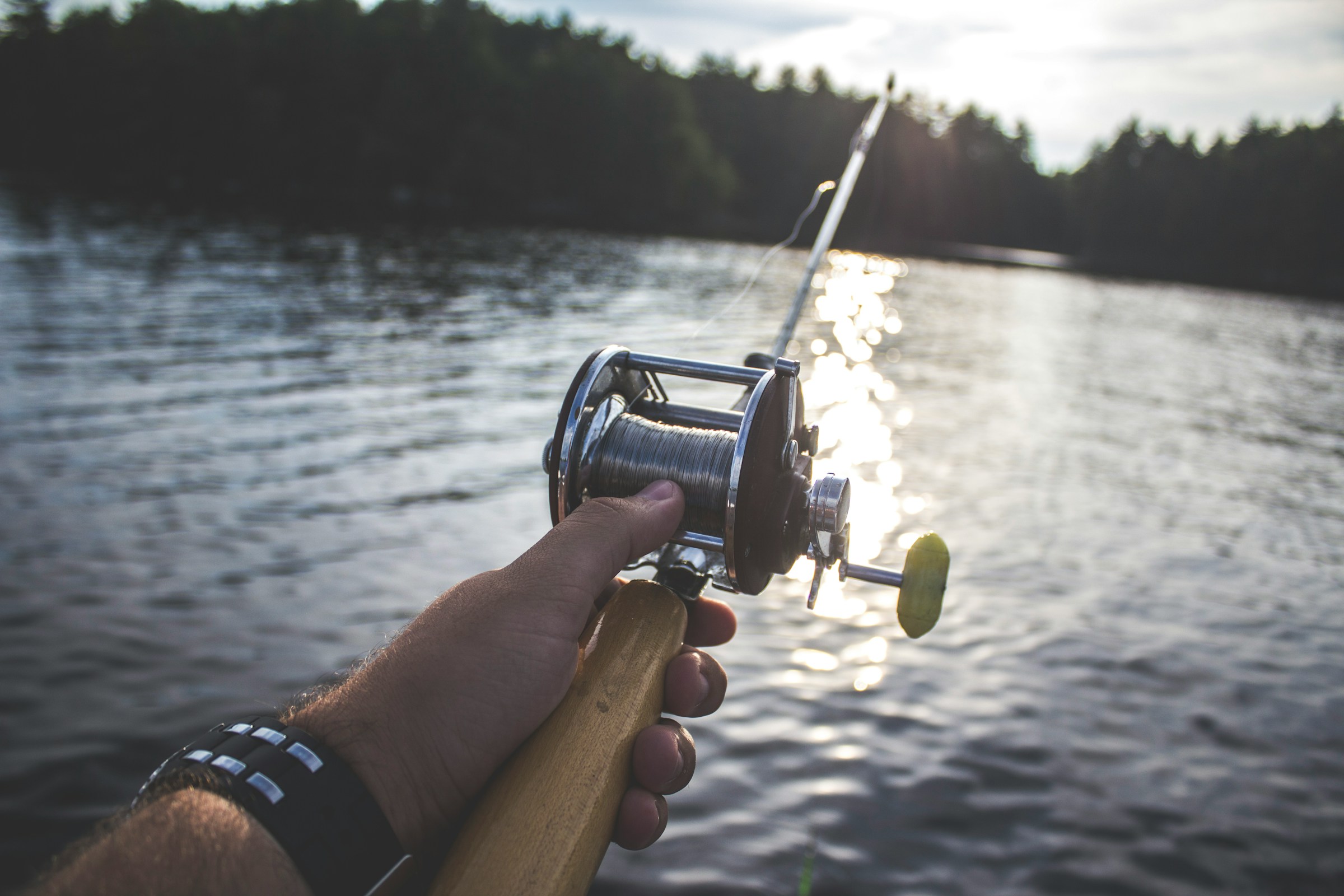 A person holding a fishing rod | Source: Unsplash