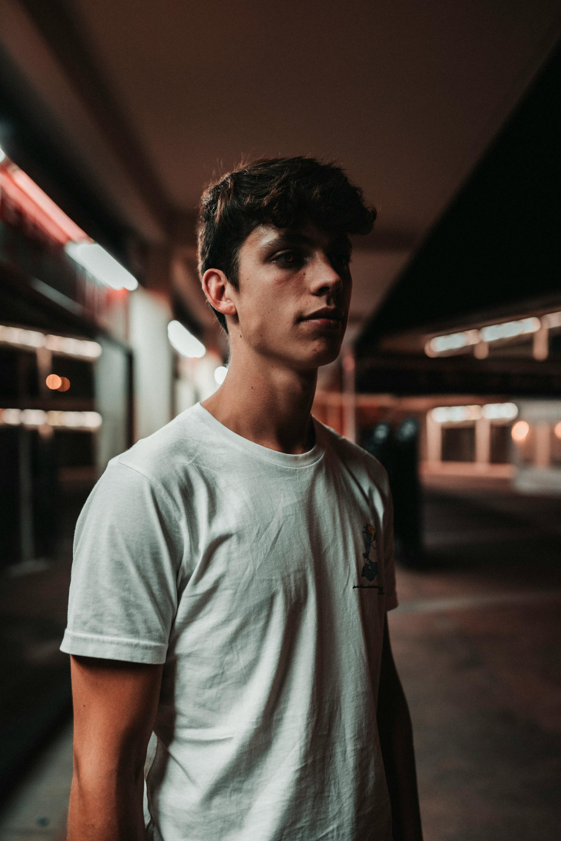 A young man standing in a parking lot | Source: Pexels