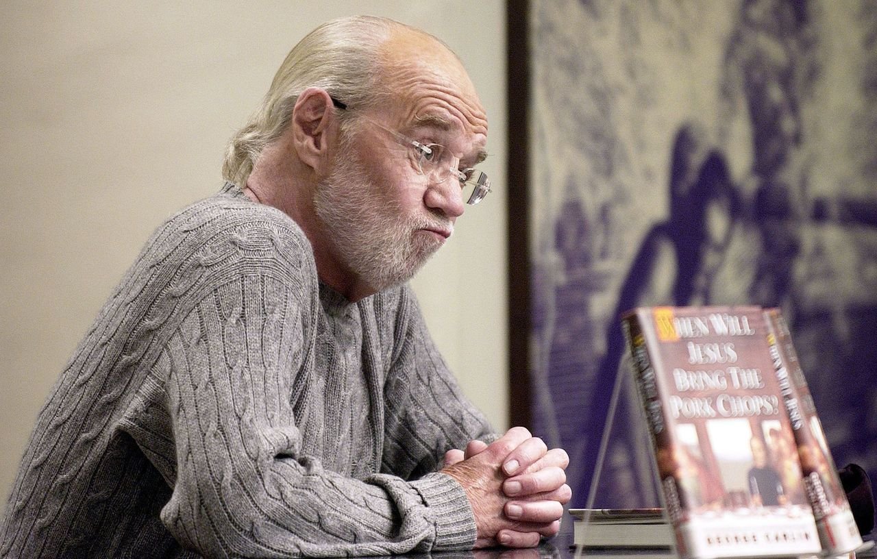 George Carlin speaks about his new book "When Will Jesus Bring The Pork Chops?" at a book signing at Barnes and Noble. | Source: Getty Images