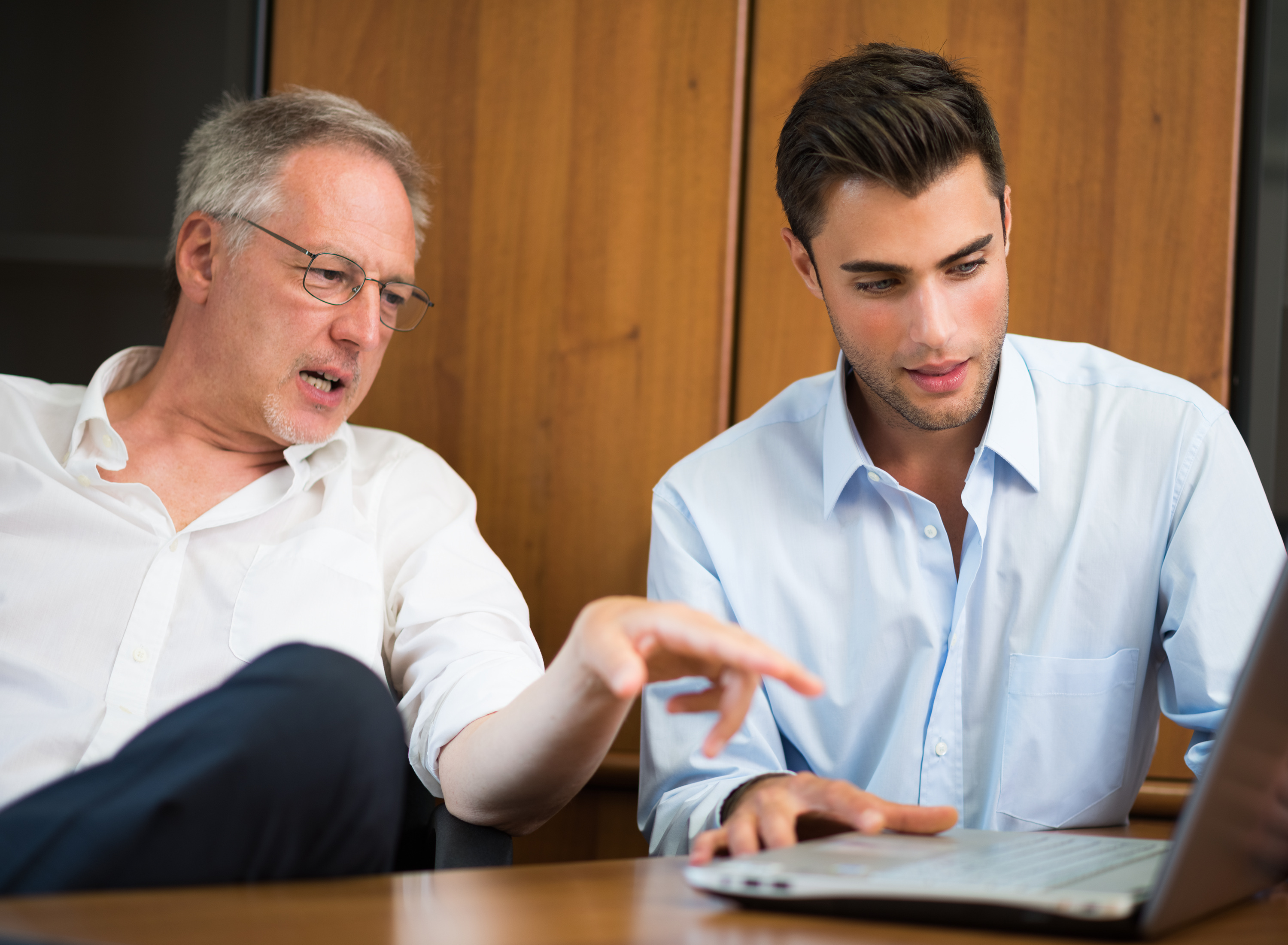 Son talks to his father at the office. | Source: Shutterstock