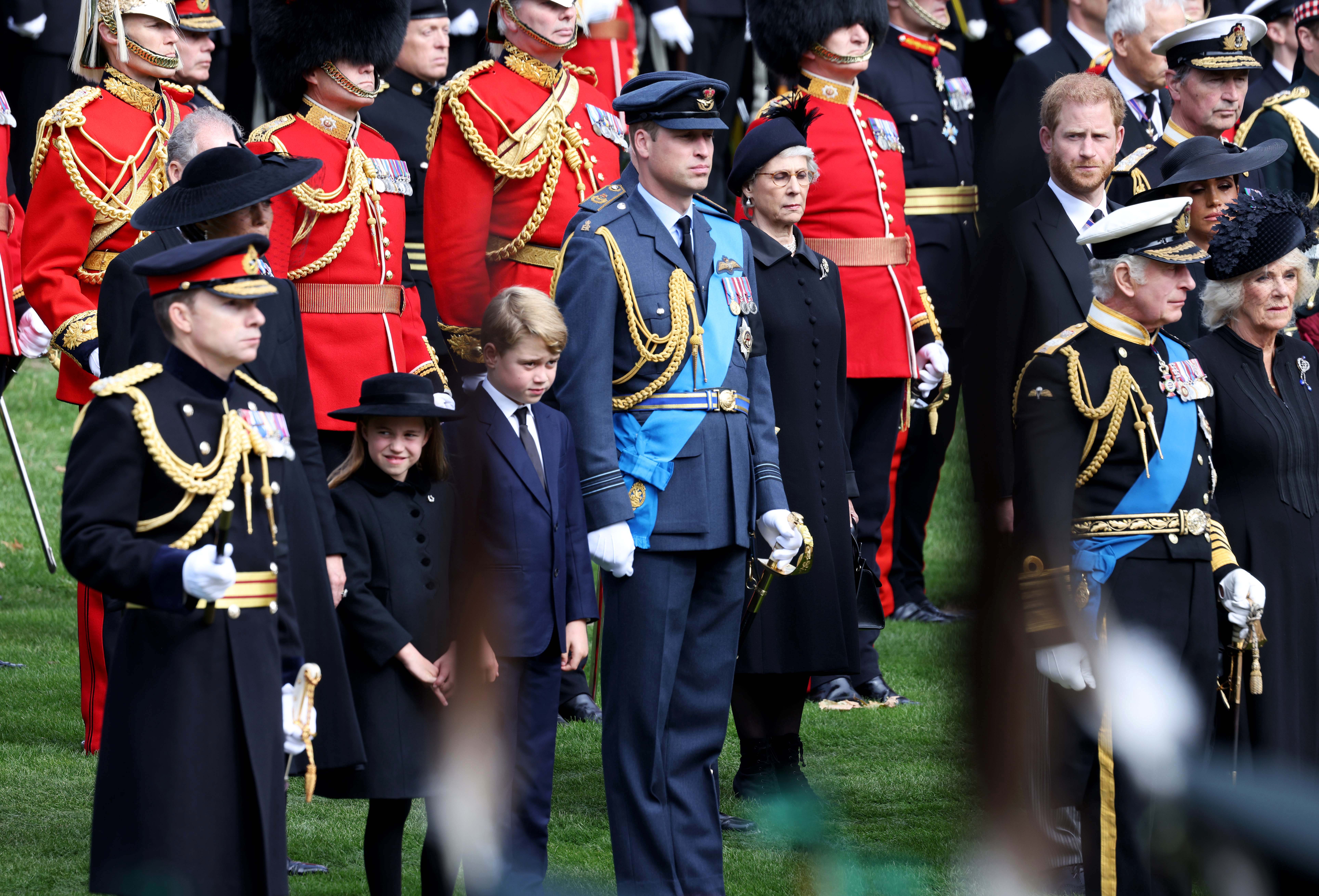 King Charles III, Camilla, Queen Consort, Prince William, Prince of Wales, Prince Harry, Duke of Sussex, Meghan, Duchess of Sussex, Catherine, Princess of Wales, Prince George of Wales, and Princess Charlotte of Wales watch the funeral procession as it passes through Wellington Arch during the state funeral of Queen Elizabeth II on September 19, 2022, in London, England. | Source: Getty Images