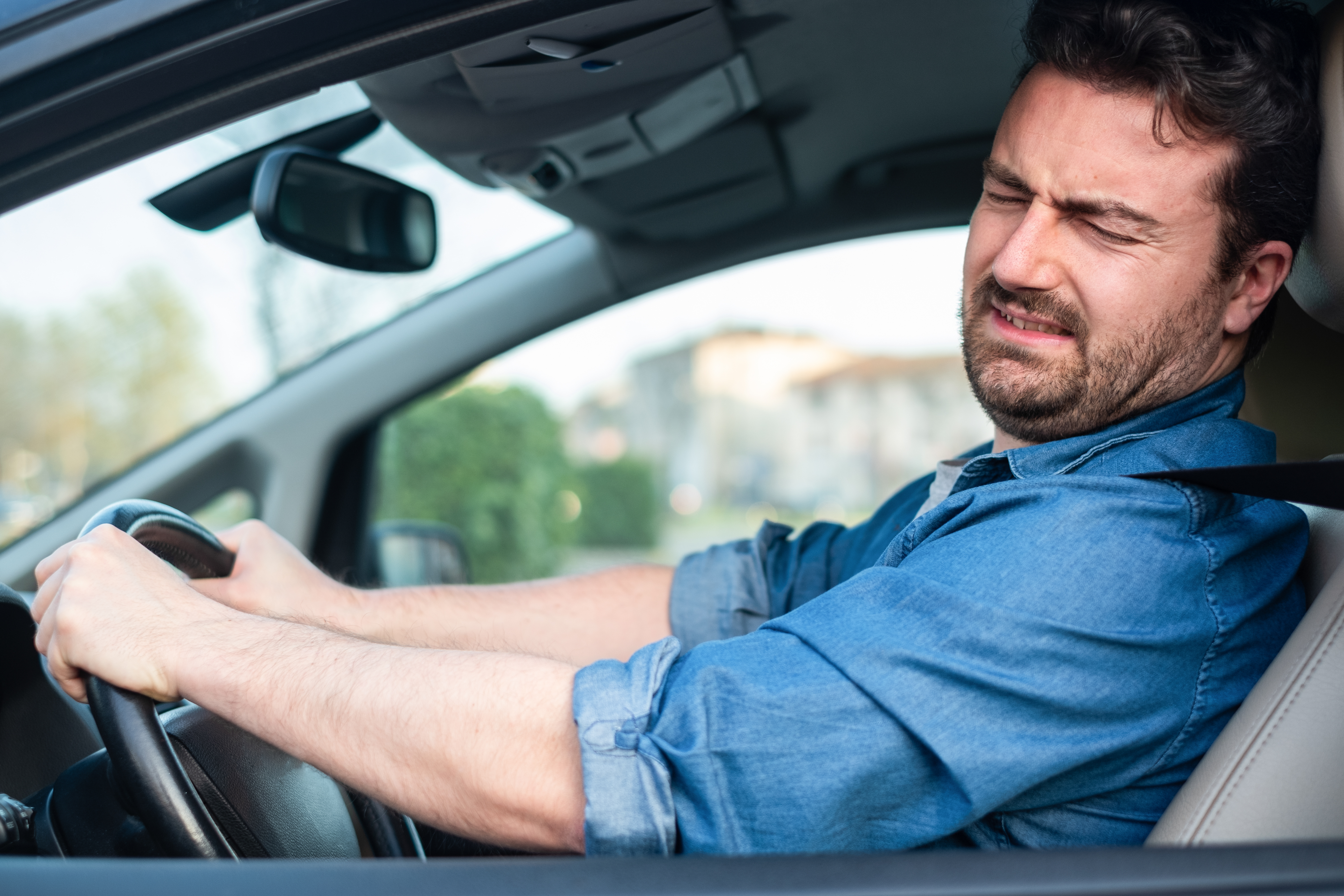A confused man in a car | Source: Shutterstock