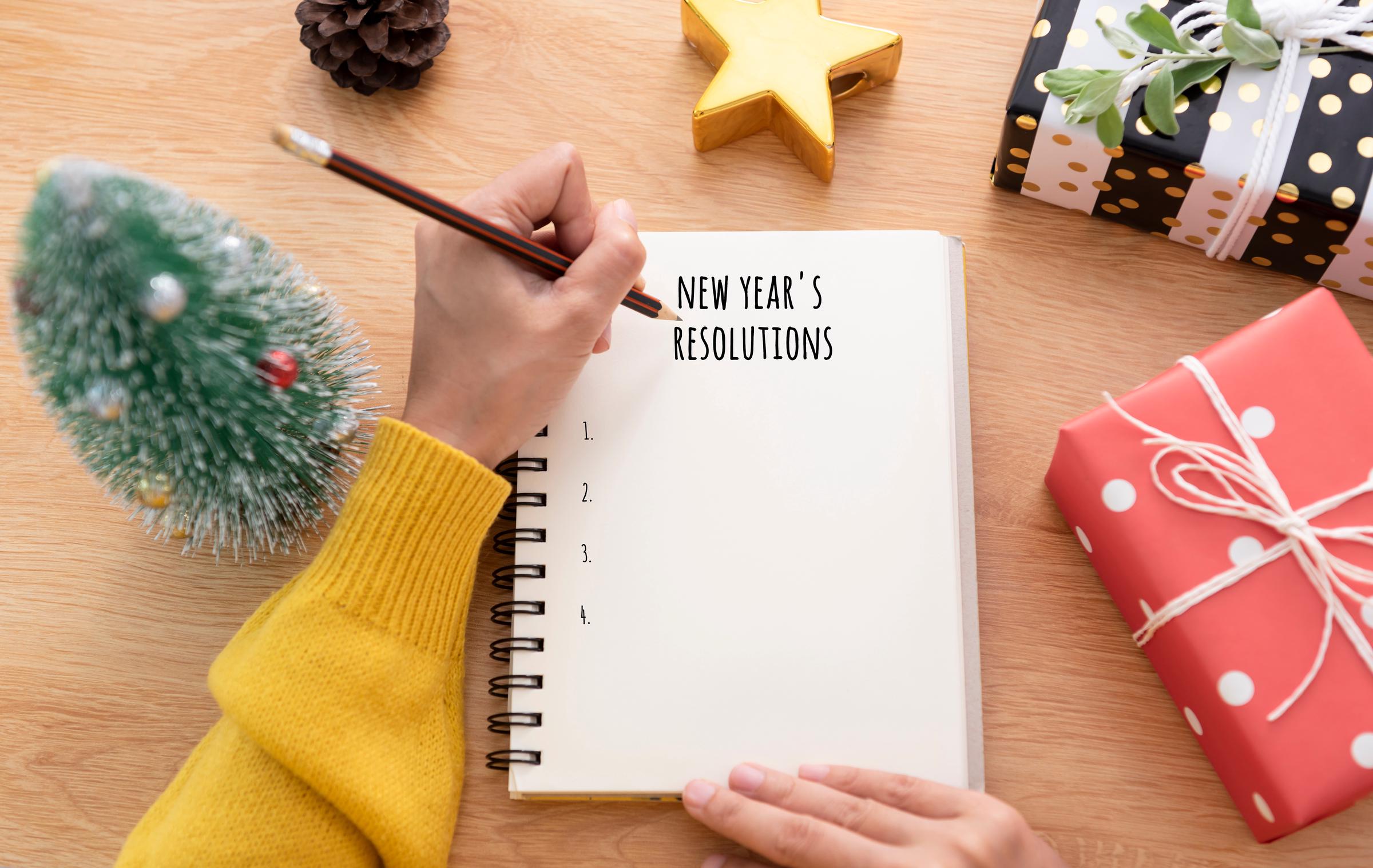 Person poised to write down her New Year's resolutions | Source: Shutterstock