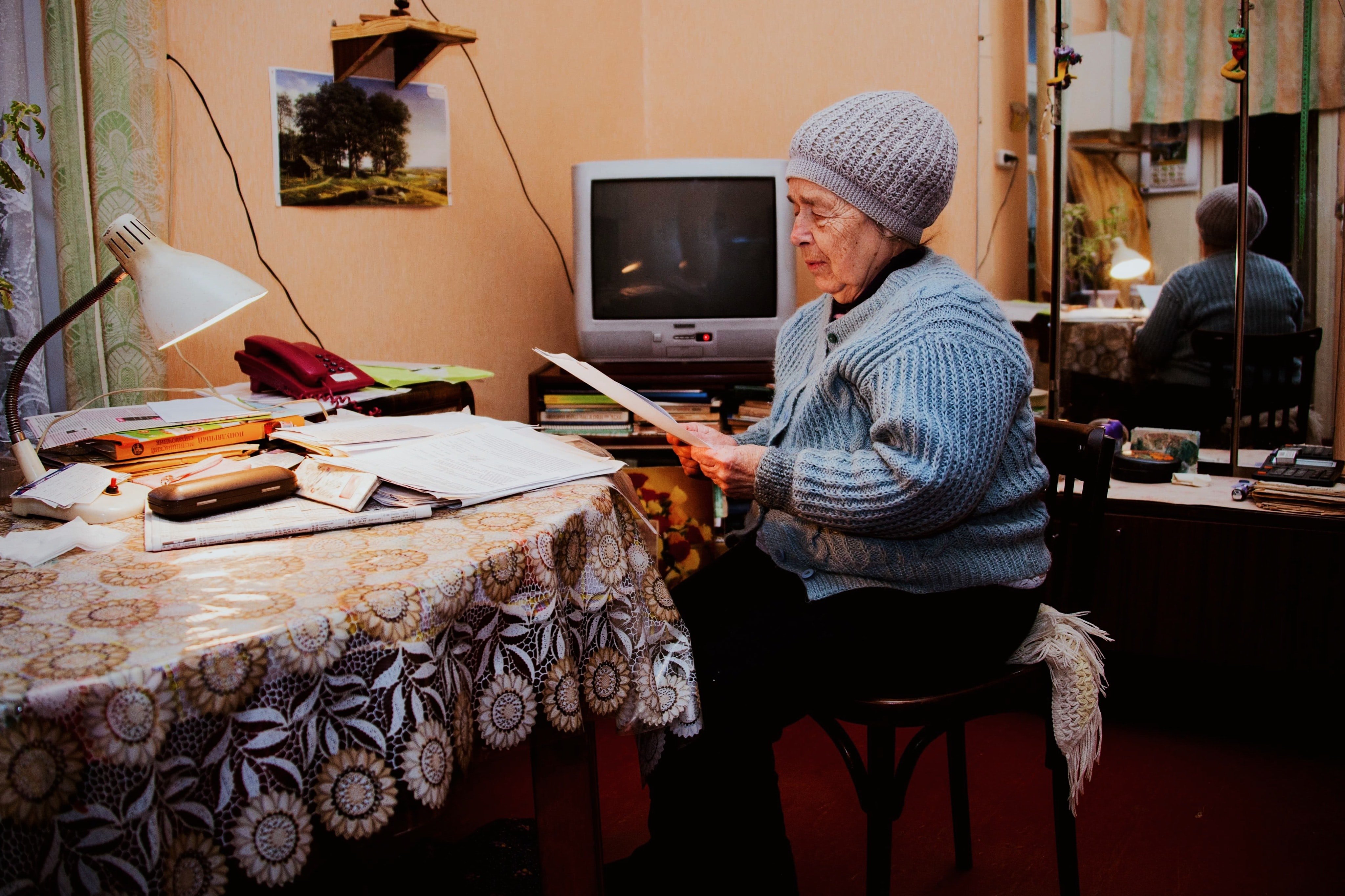 An older woman looking through paperwork | Source: Unsplash