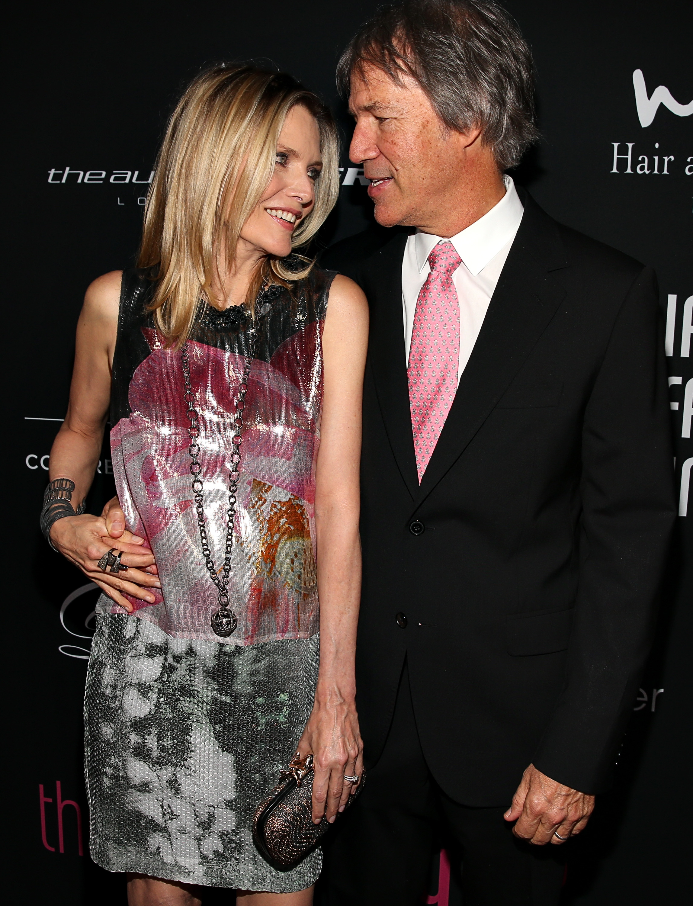 Actress Michelle Pfeiffer and her husband, writer/producer David E. Kelley, arrive at the 8th annual Pink Party at HANGAR:8 on October 27, 2012 in Santa Monica, California. | Source: Getty Images