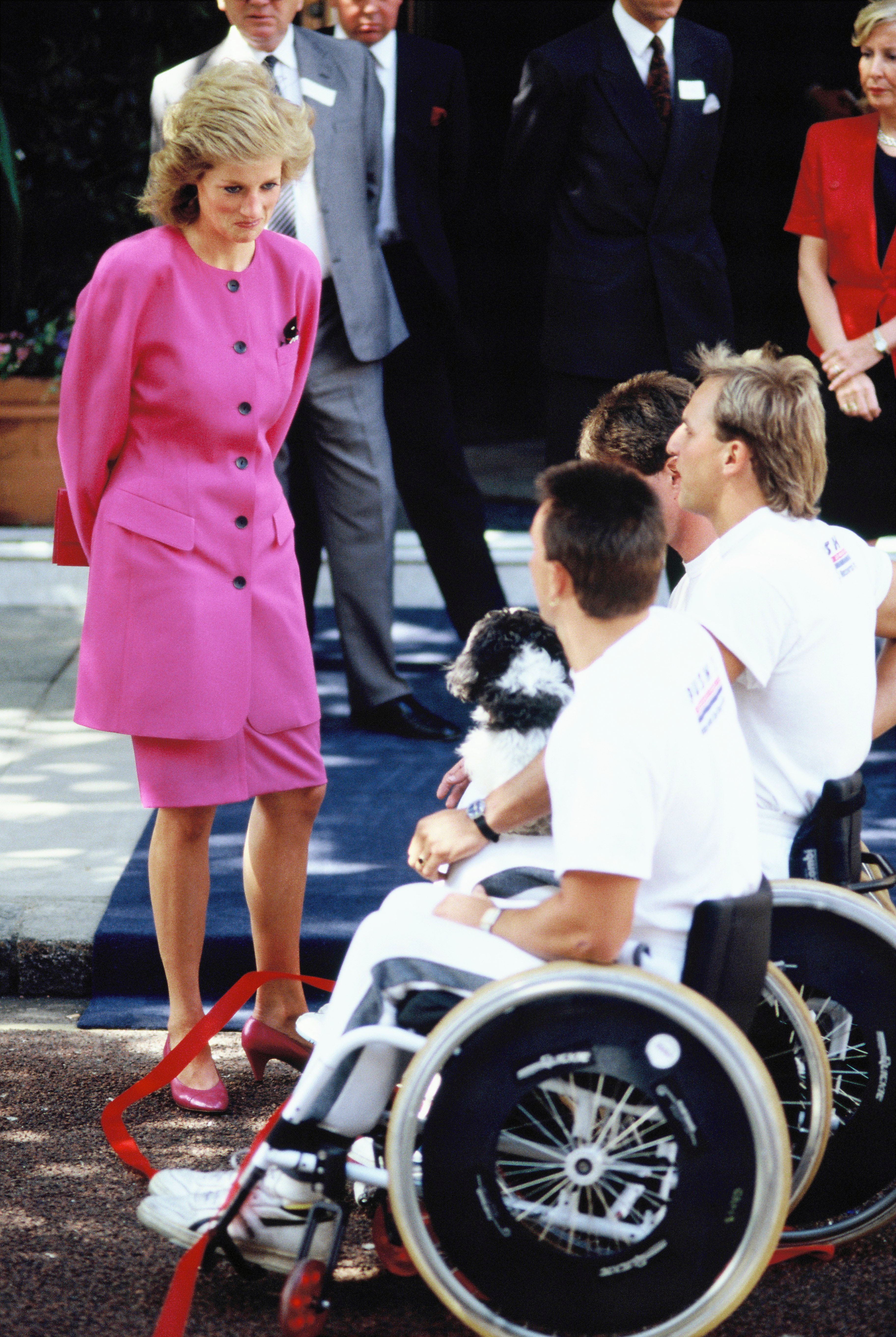 Diana, Princess of Wales, visits people in wheelchairs in 1988. | Source: Getty Images