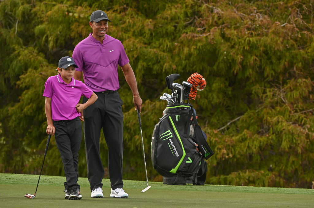 Tiger Woods smiles beside Charlie Woods on the 16th green at the PNC Championship in Orlando on December 19, 2020. Their sync and matching look made headlines that weekend.