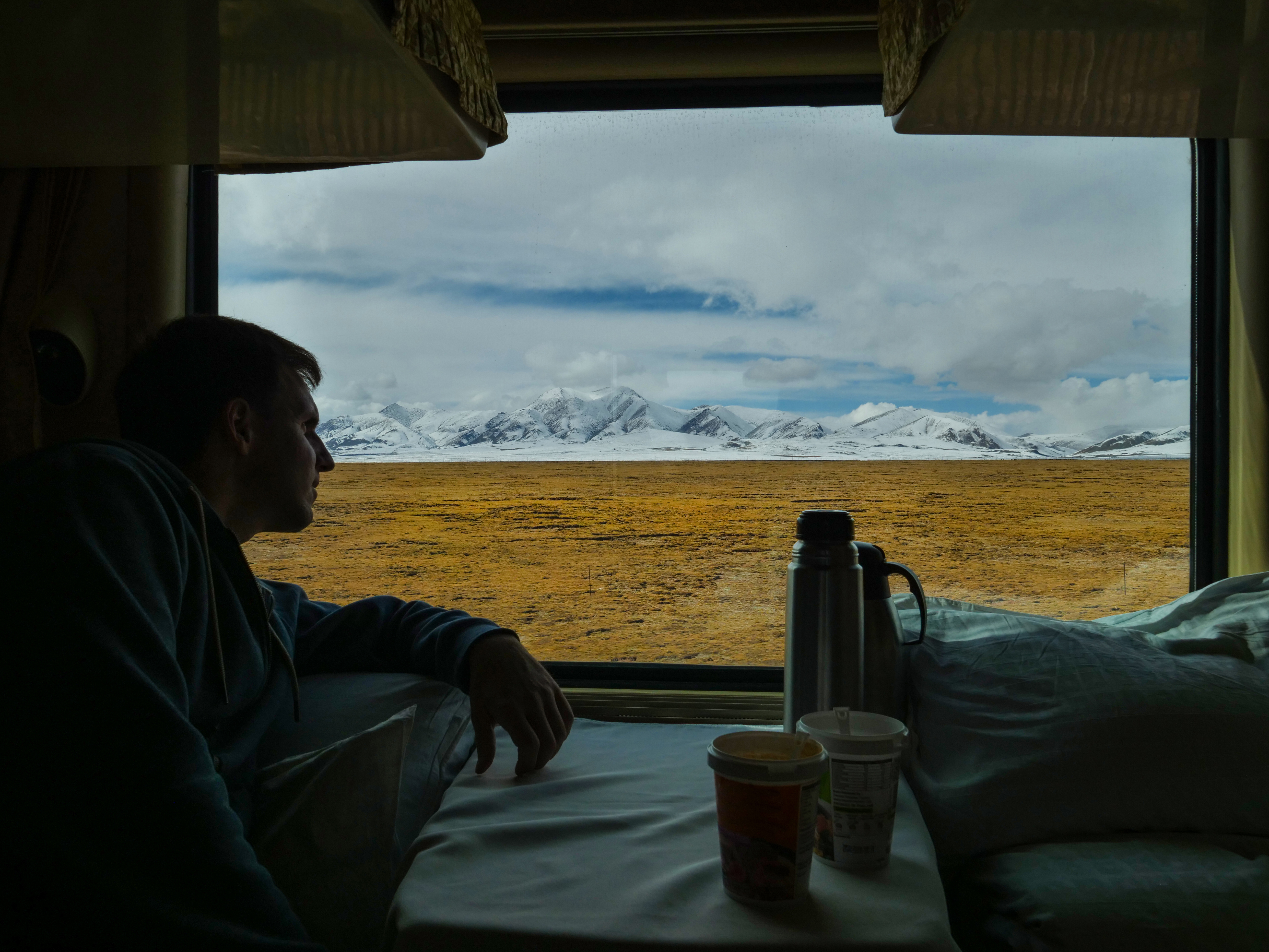 A man sitting in a first-class train cabin | Source: Shutterstock