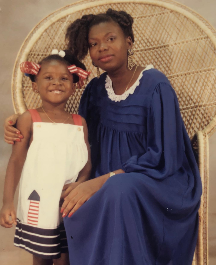 In a warm, vintage portrait, a young Nancy Metayer Bowen sits close to her mother, both framed by a woven chair that adds a soft, nostalgic texture to the moment. | Source: Instagram/nancymetayerbowen