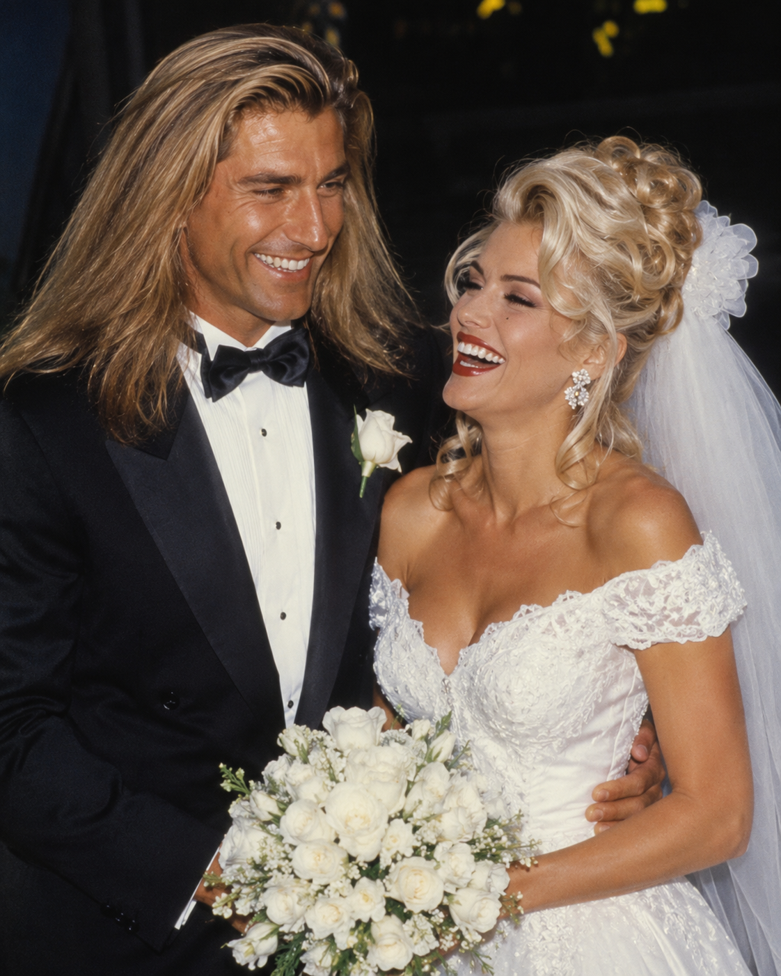This AI-imagined portrait captures a glowing Anna Nicole Smith laughing alongside Fabio on their wedding day, featuring an ornate bridal updo and tuxedo combination typical of high-profile nuptials. | Source: ChatGPT