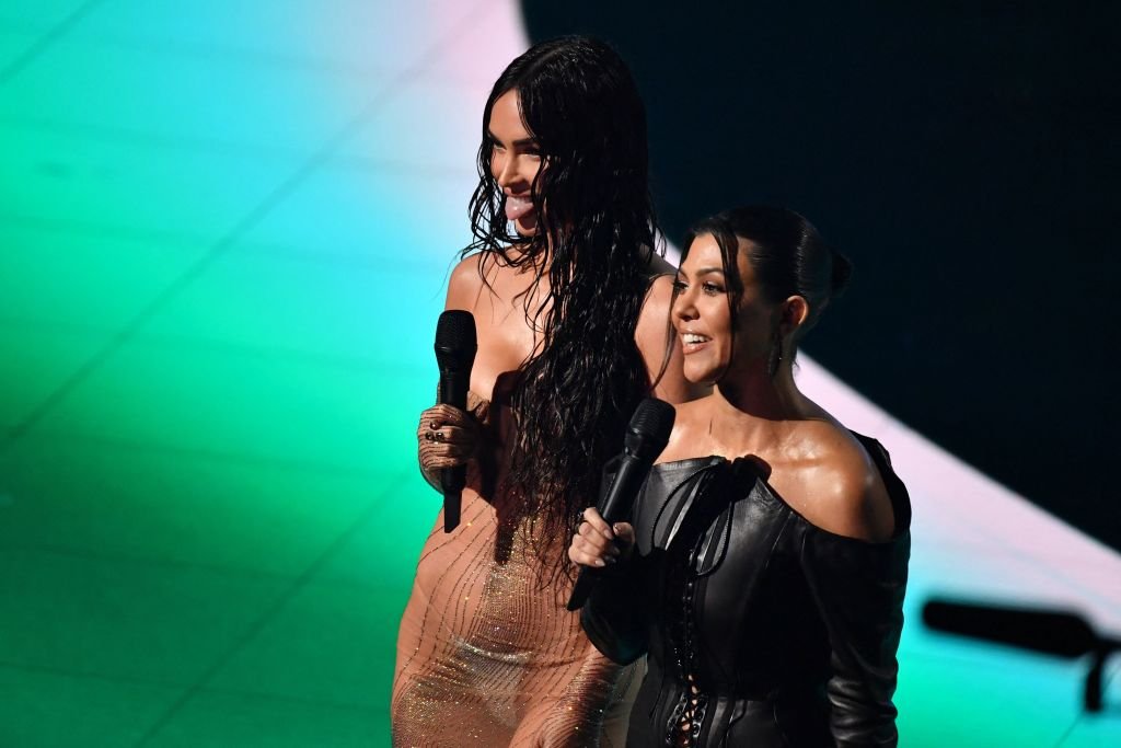 Megan Fox and Kourtney Kardashian speak on stage during the 2021 MTV Video Music Awards, September 2021 | Source: Getty Images