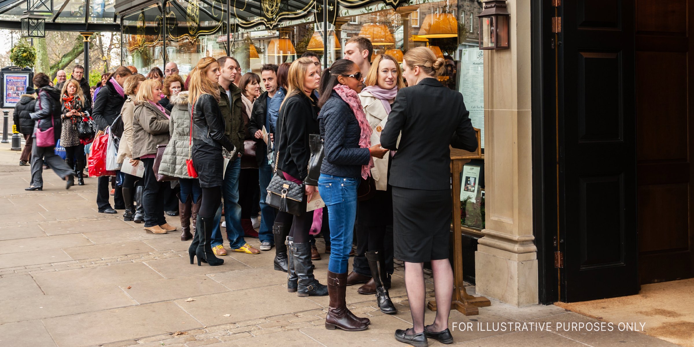 Customers lined up outside an eatery. | Source: Shutterstock