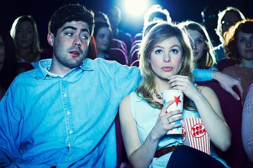 A couple pictured enjoying a movie at the cinema | Photo: Getty Images