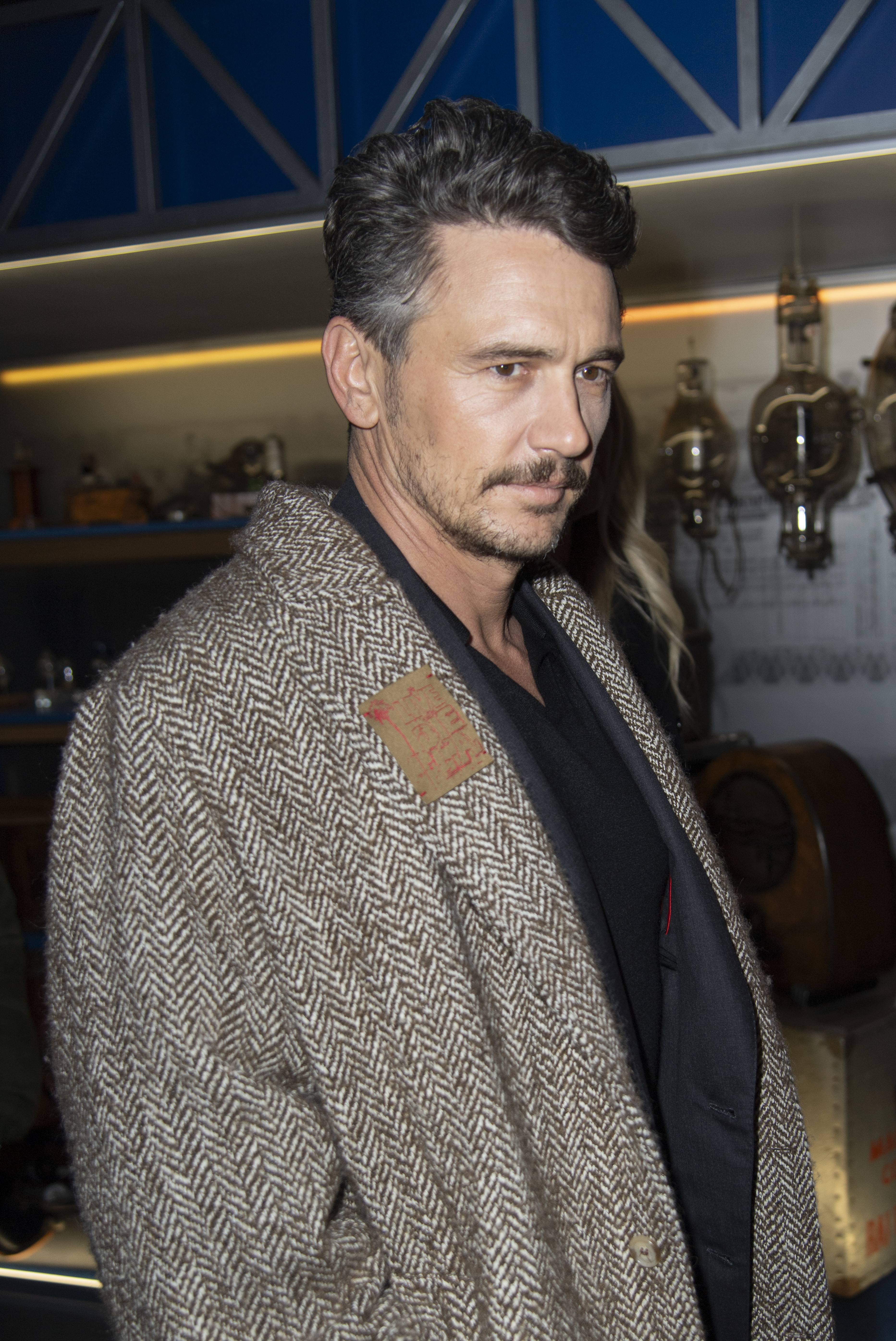 In a rare posed moment at the Torino Film Festival, James Franco gives a composed look to the camera. His structured coat and slicked-back hair reflect a more refined public image.